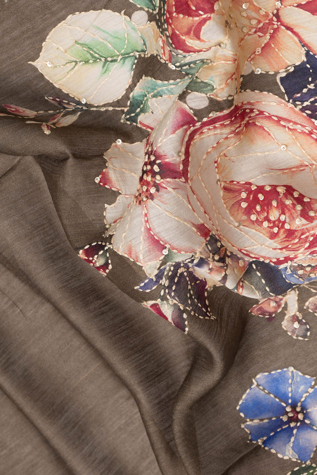 Close up of Brown Dual Tone Tussar Silk Saree with Embroidery on the body and Zari Border.  displaying folds