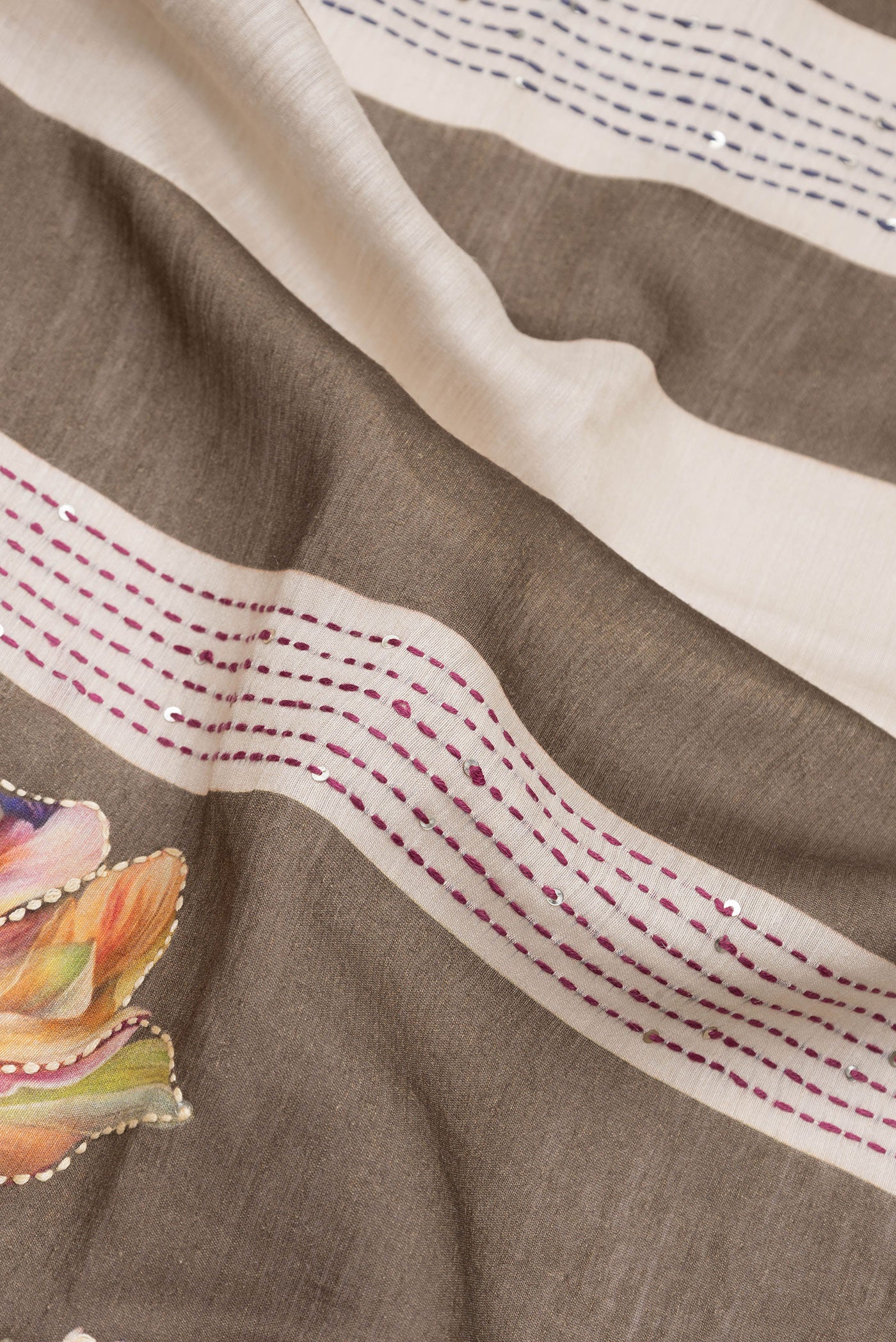 Close up of Mehandi Green Dual Tone Tussar Silk Saree with Embroidery on the body and Zari Border.  displaying folds