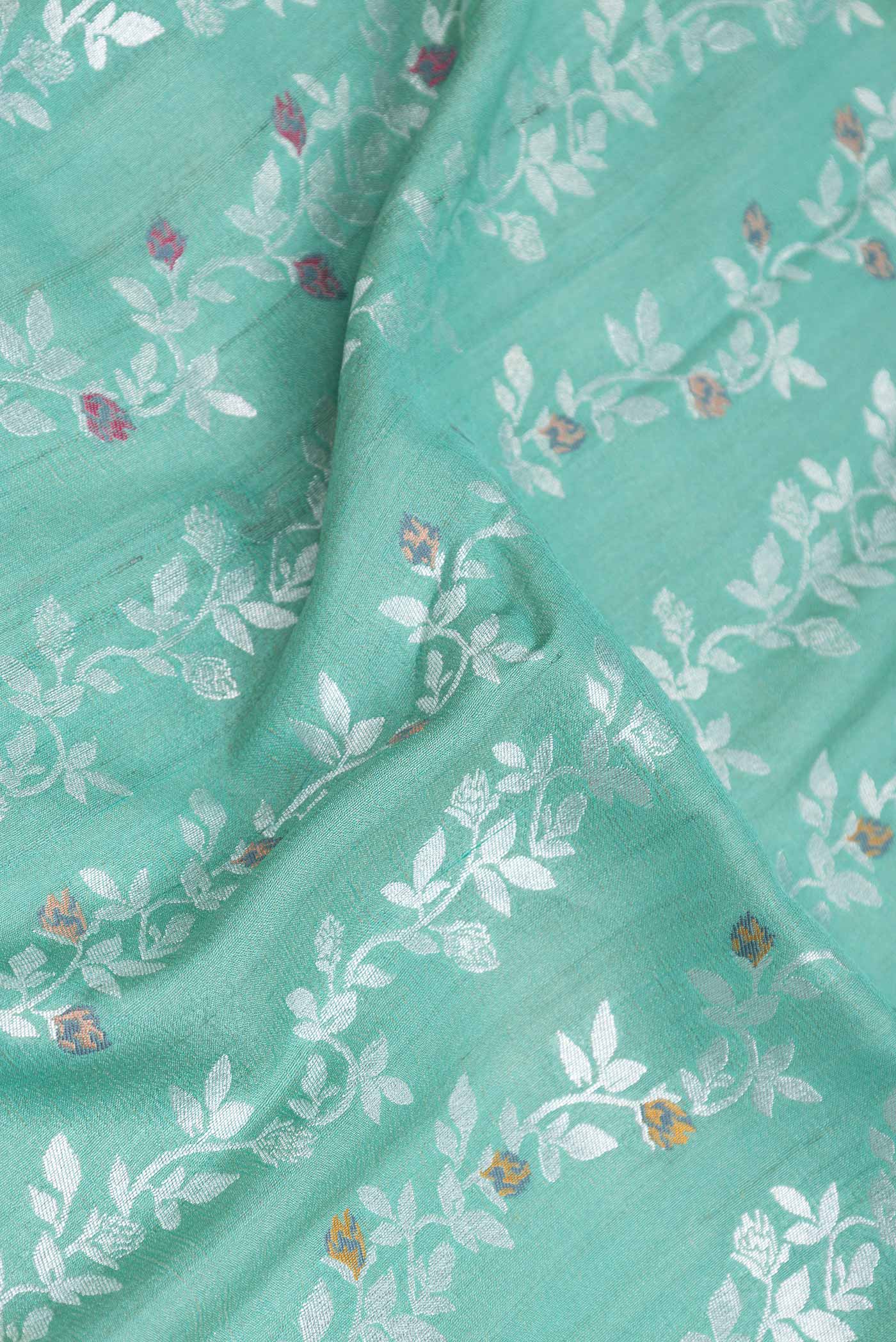 Close up of Light Green Dual Tone Banarasi Silk Saree with Zari Brocade on the body and Zari Border displaying folds
