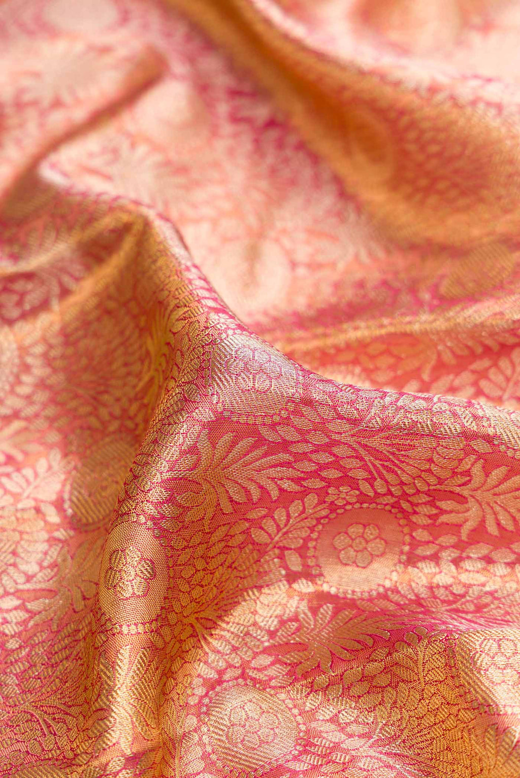 Close up of Pink Dual Tone Kanchipuram Tissue Silk Saree with Zari Brocade on the body and Zari Border.  displaying folds
