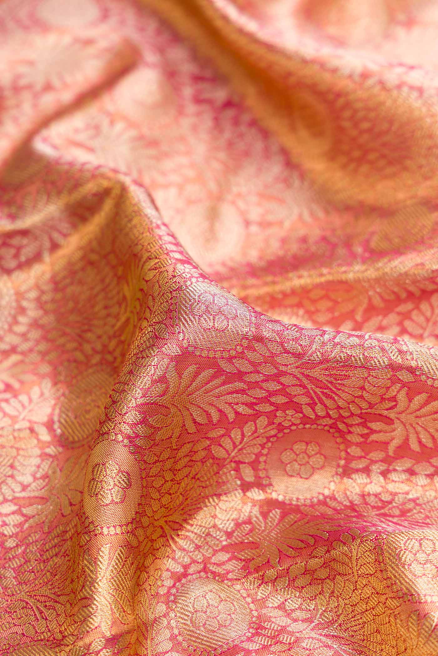 Close up of Pink Dual Tone Kanchipuram Tissue Silk Saree with Zari Brocade on the body and Zari Border.  displaying folds