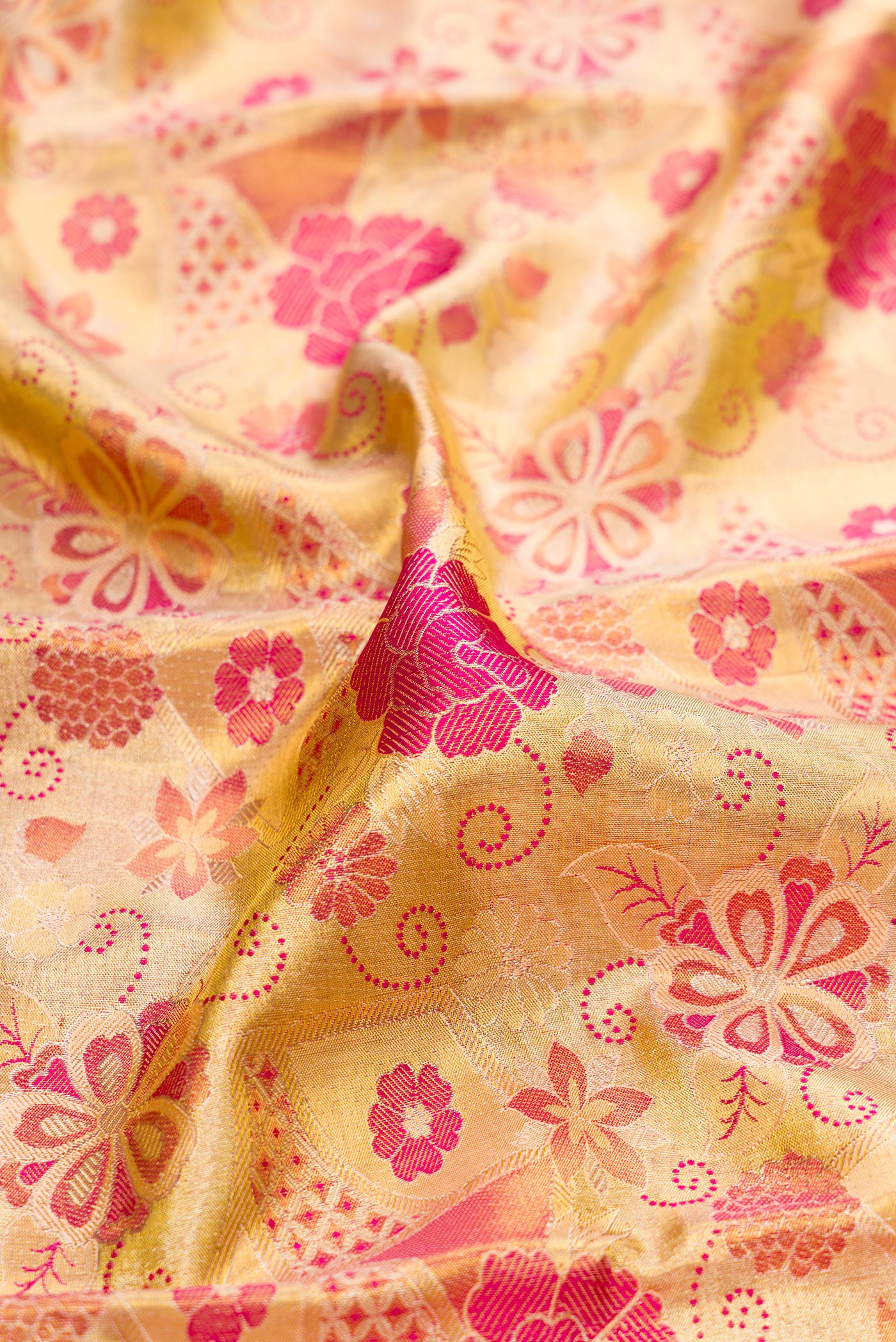 Close up of Gold Dual Tone Kanchipuram Tissue Silk Saree with Zari Brocade on the body and Zari Border.  displaying folds