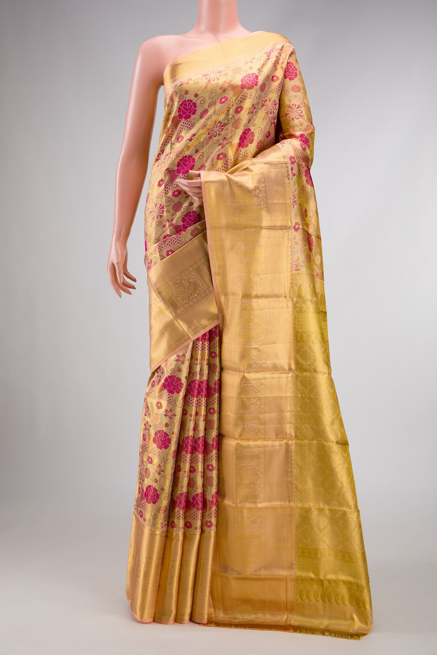Gold Dual Tone Kanchipuram Tissue Silk Saree with Zari Brocade on the body and Zari Border.  displayed on a mannequin