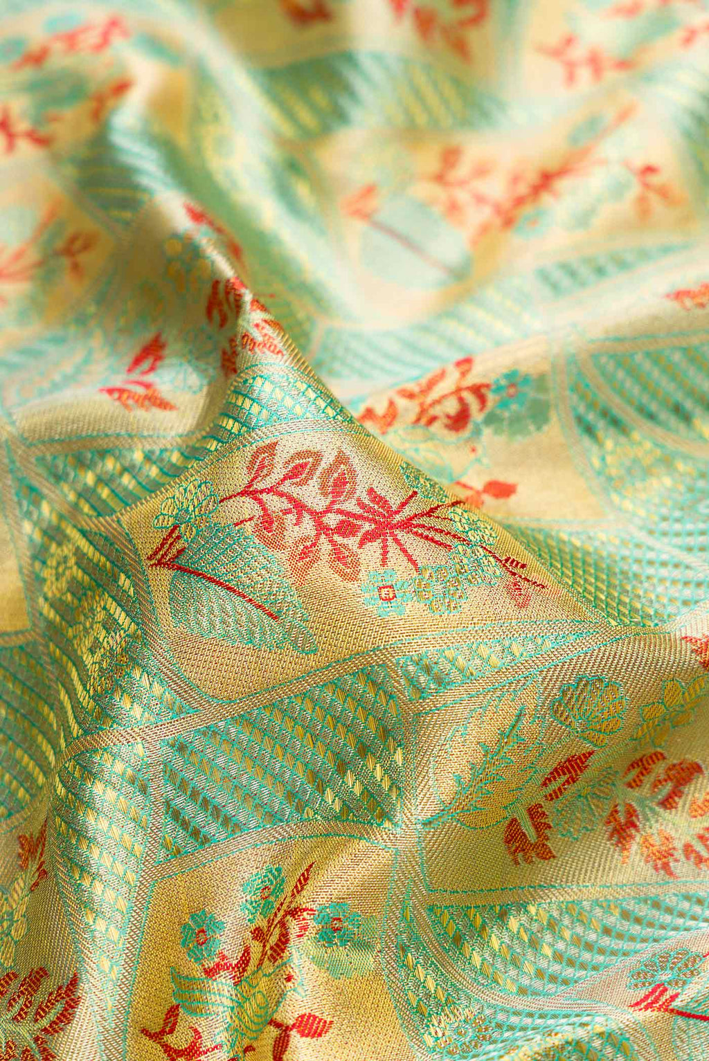 Close up of Green Dual Tone Kanchipuram Tissue Silk Saree with Zari Brocade on the body and Fancy Border.  displaying folds