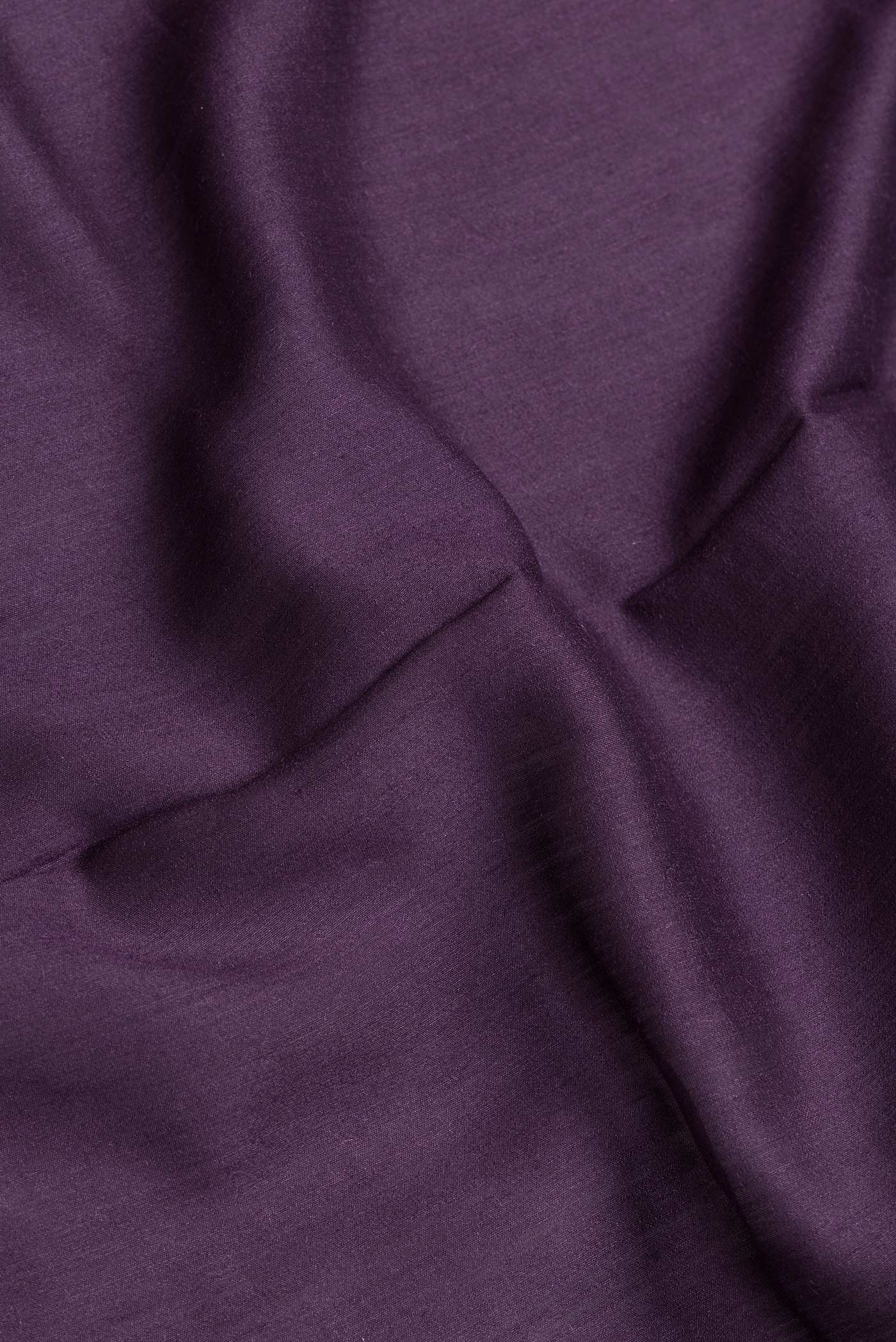 Close up of Burgundy Dual Tone Tussar Silk Saree with Plain Body and Fancy Border.  displaying folds