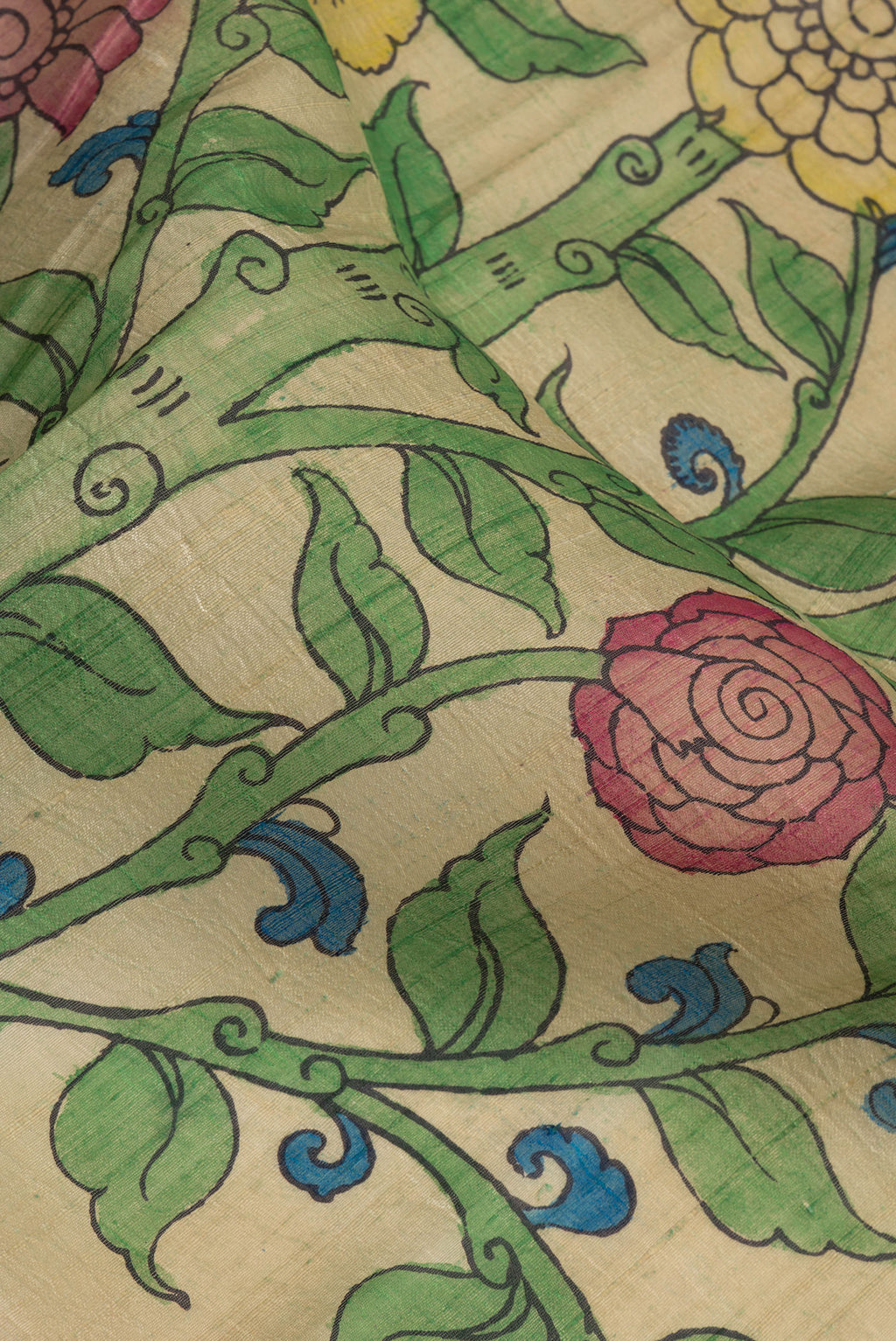 Close up of Beige Dual Tone Raw Silk Saree with kalamkari Print on the body and Zari Border.  displaying folds