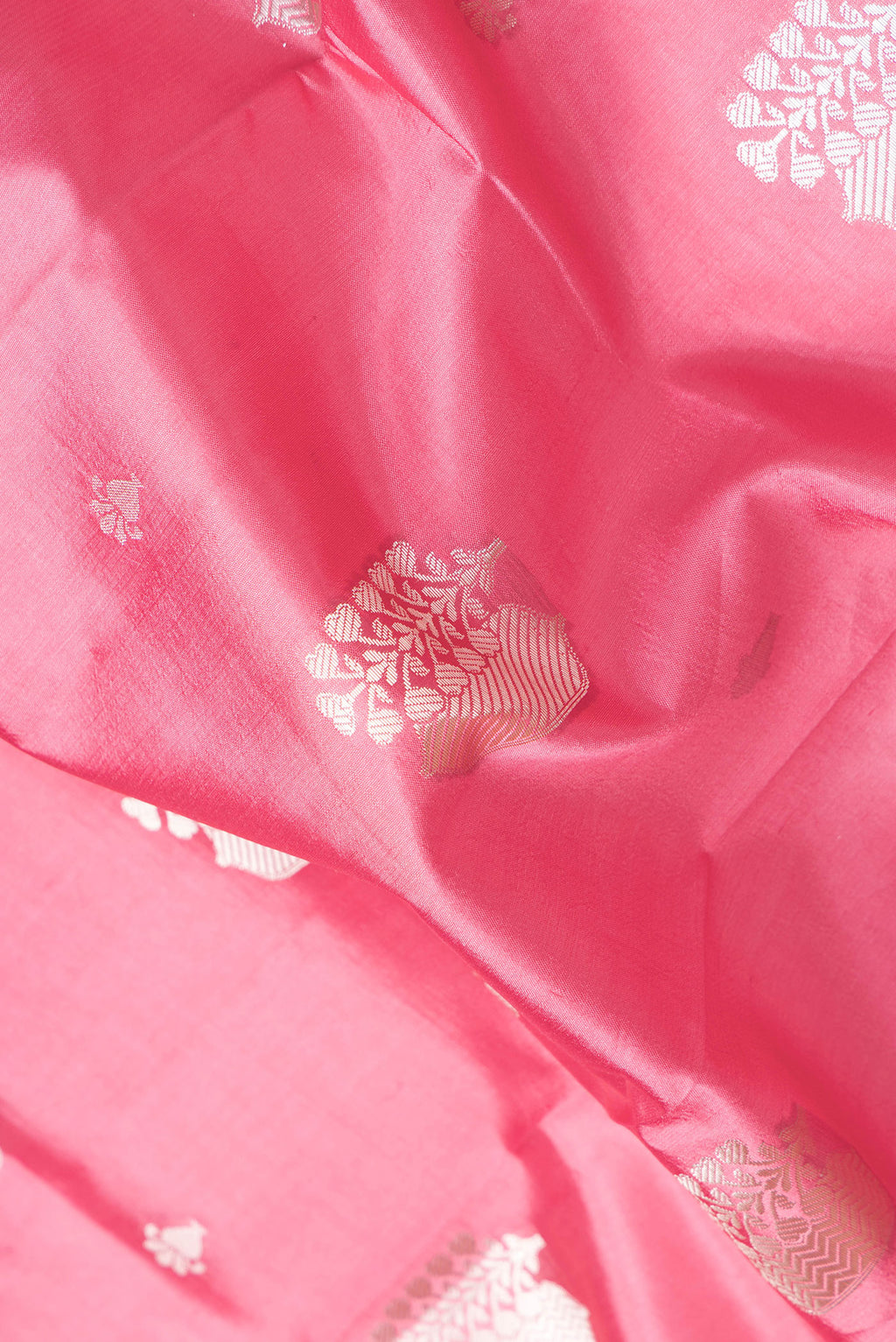 Close up of Pink Dual Tone Tussar Silk Saree with Zari Butta on the body and Zari Border.  displaying folds