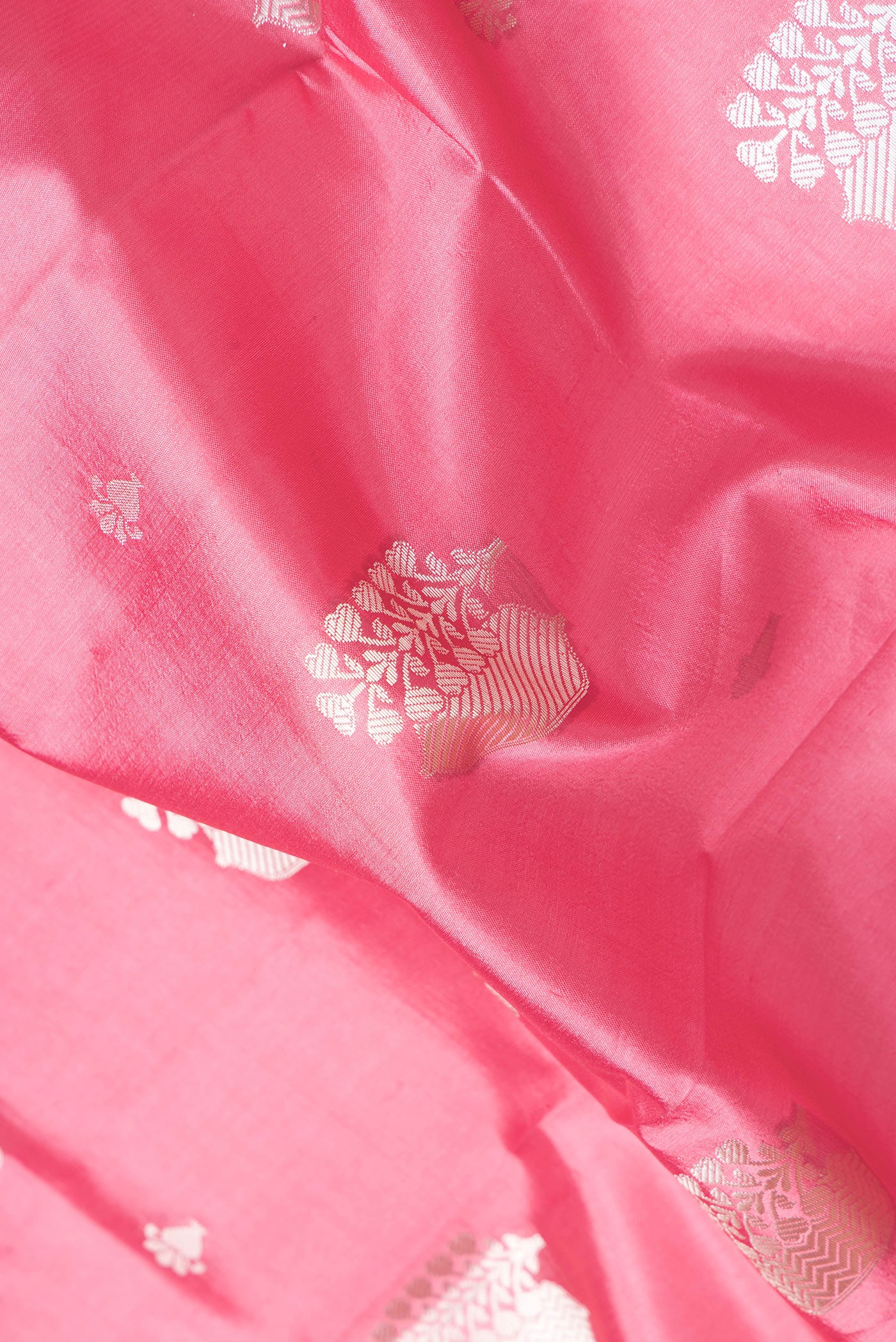 Close up of Pink Dual Tone Tussar Silk Saree with Zari Butta on the body and Zari Border.  displaying folds