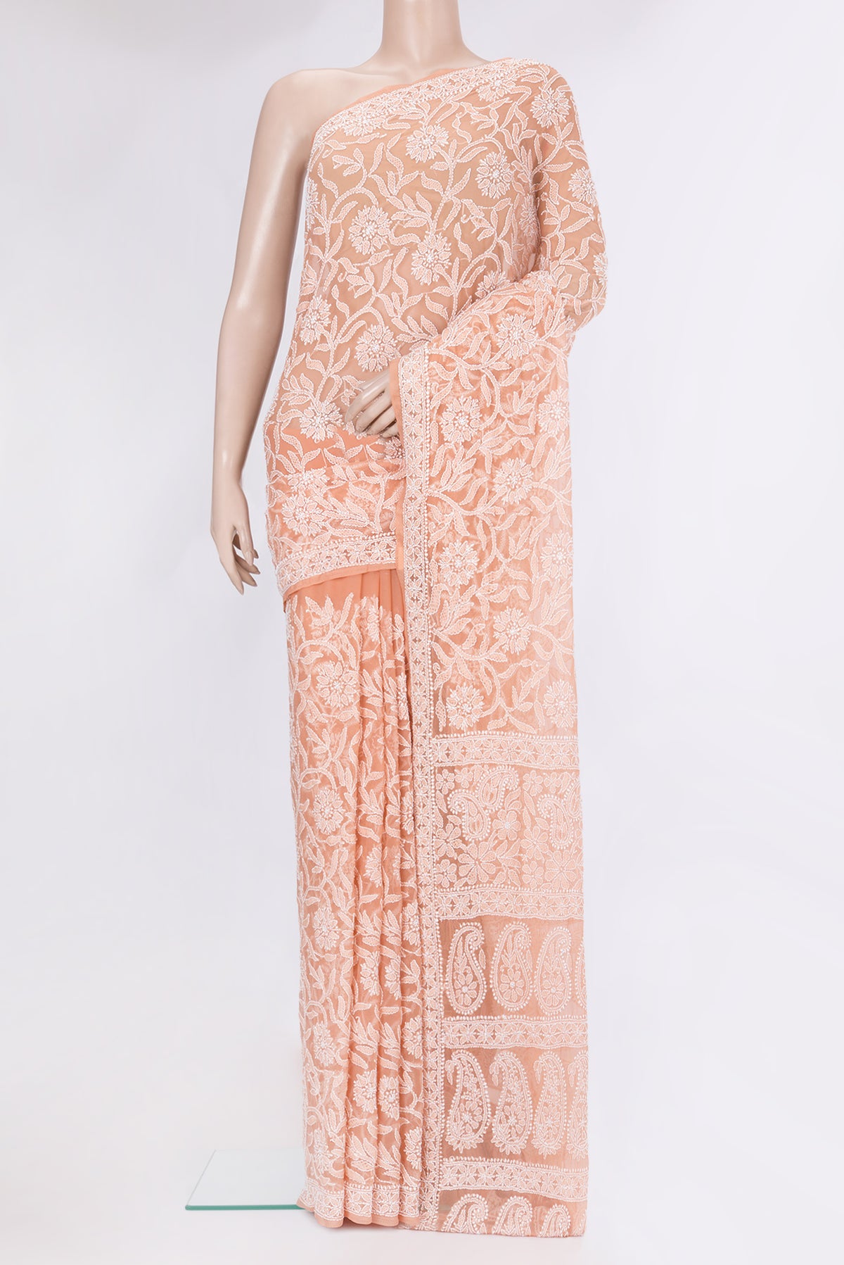 Peach Georgette Saree with Embroidery on the body and Embroidery Border.  displayed on a mannequin