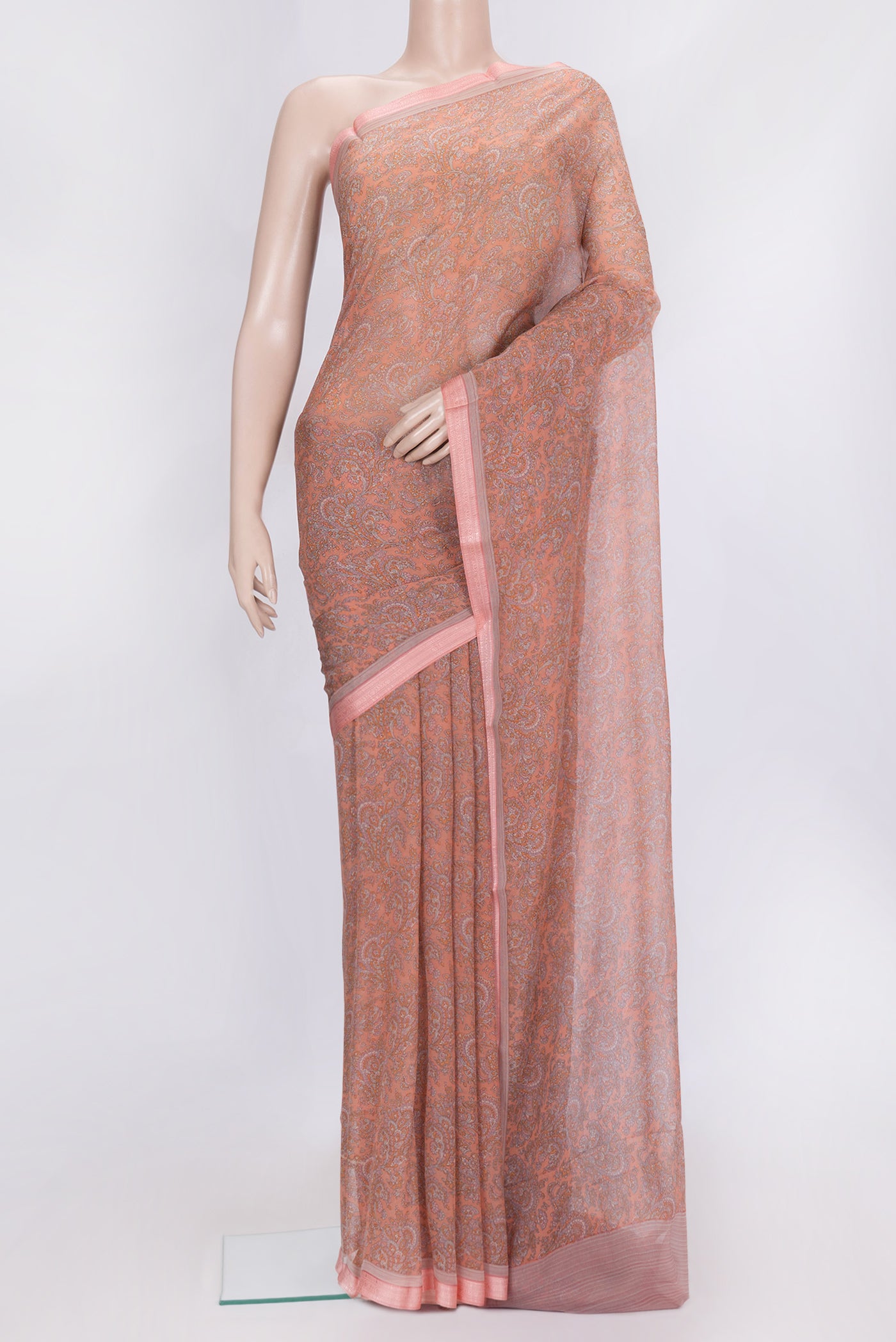 Peach Dual Tone Mysore Chiffon Saree with Printed design on the body and Thread Border.  displayed on a mannequin