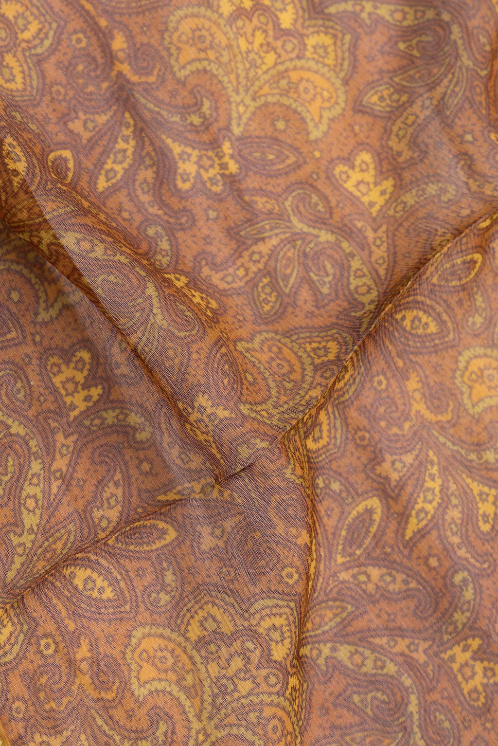 Close up of Mustard Dual Tone Mysore Georgette Saree with Printed design on the body and Zari Border.  displaying folds