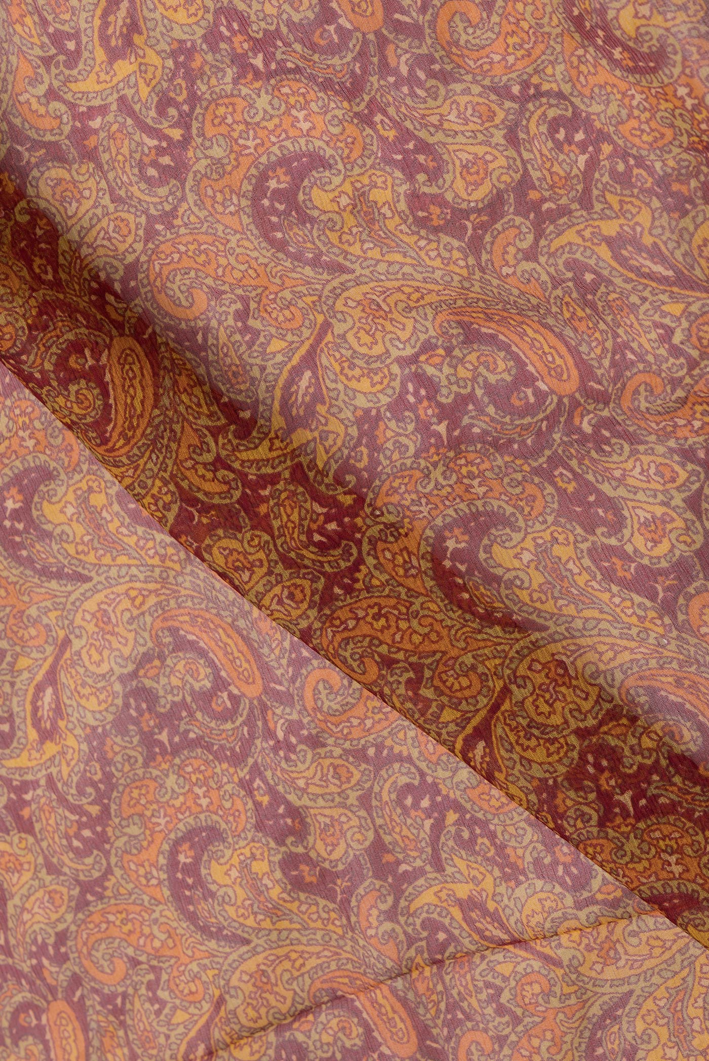 Close up of Maroon Dual Tone Mysore Chiffon Saree with Printed design on the body and Zari Border.  displaying folds