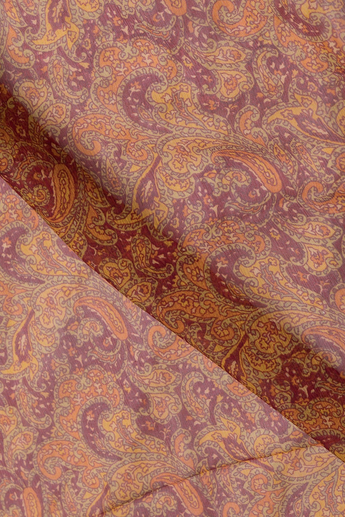 Close up of Maroon Dual Tone Mysore Chiffon Saree with Printed design on the body and Zari Border.  displaying folds