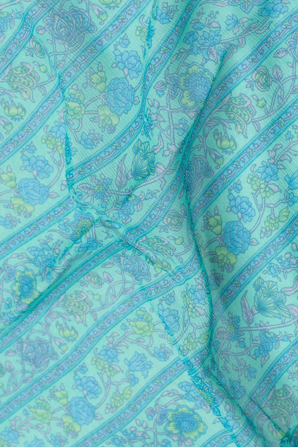 Close up of Sea Green Dual Tone Mysore Chiffon Saree with Printed design on the body and Zari Border.  displaying folds