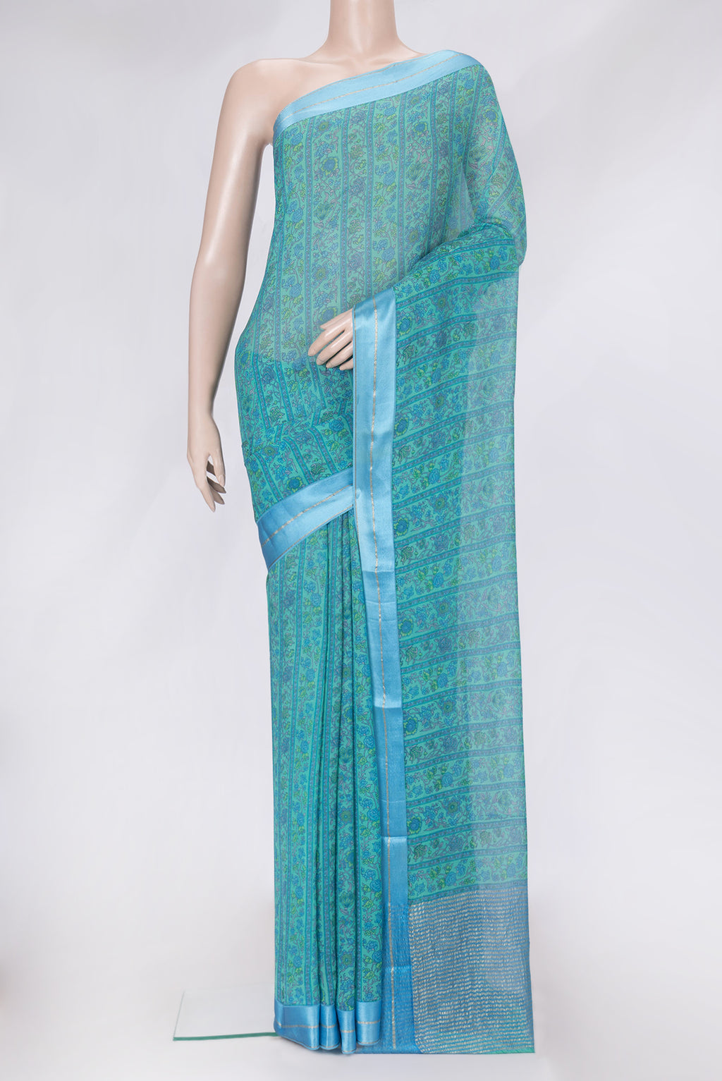 Sea Green Dual Tone Mysore Chiffon Saree with Printed design on the body and Zari Border.  displayed on a mannequin