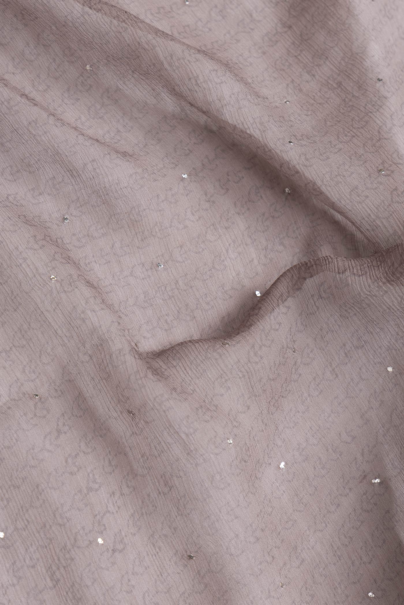 Close up of Grey Dual Tone Mysore Chiffon Saree with Printed design on the body and Embroidery Border.  displaying folds