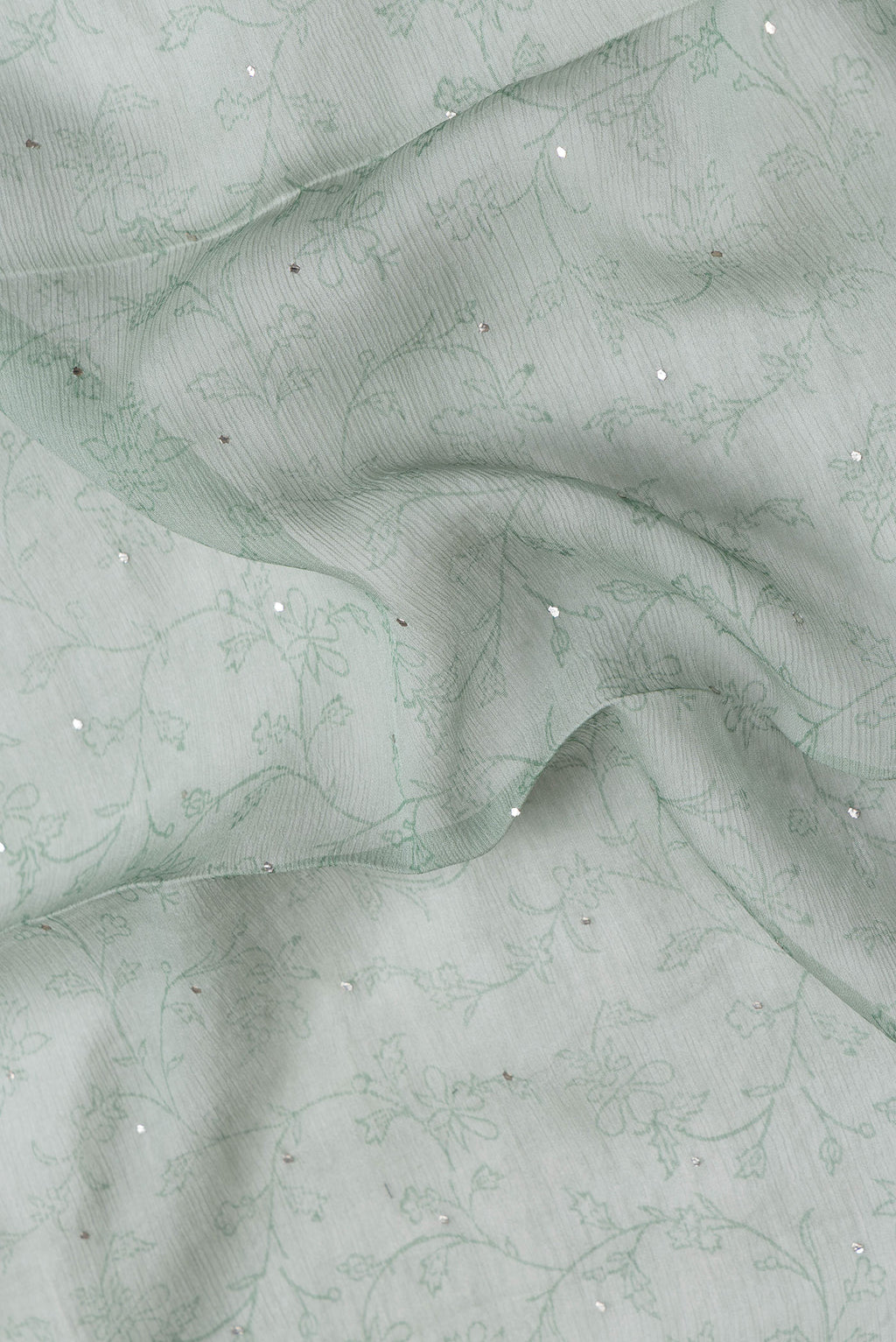 Close up of Light Green Dual Tone Mysore Chiffon Saree with Embroidery on the body and Embroidery Border.  displaying folds
