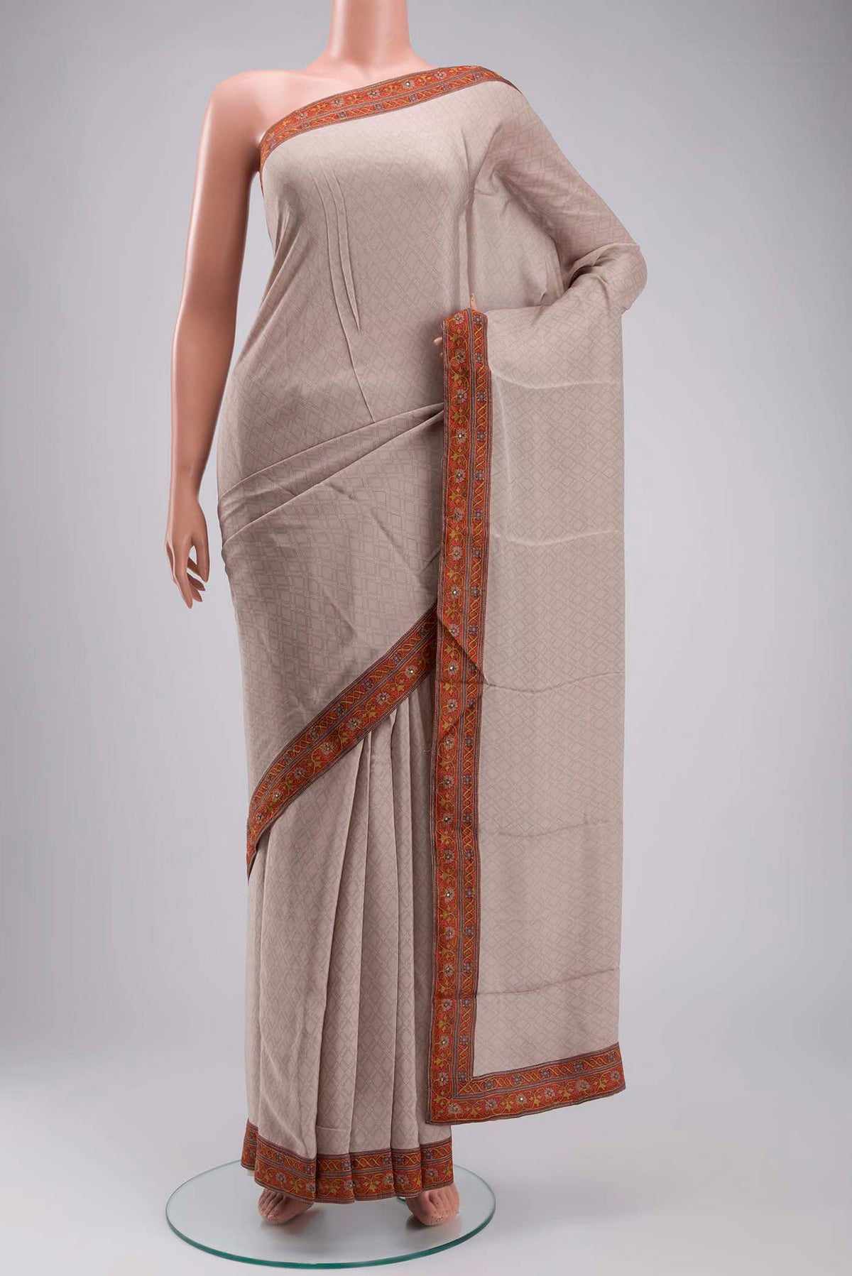 Grey Crepe Saree with Printed design on the body and Embroidery Border displayed on a mannequin