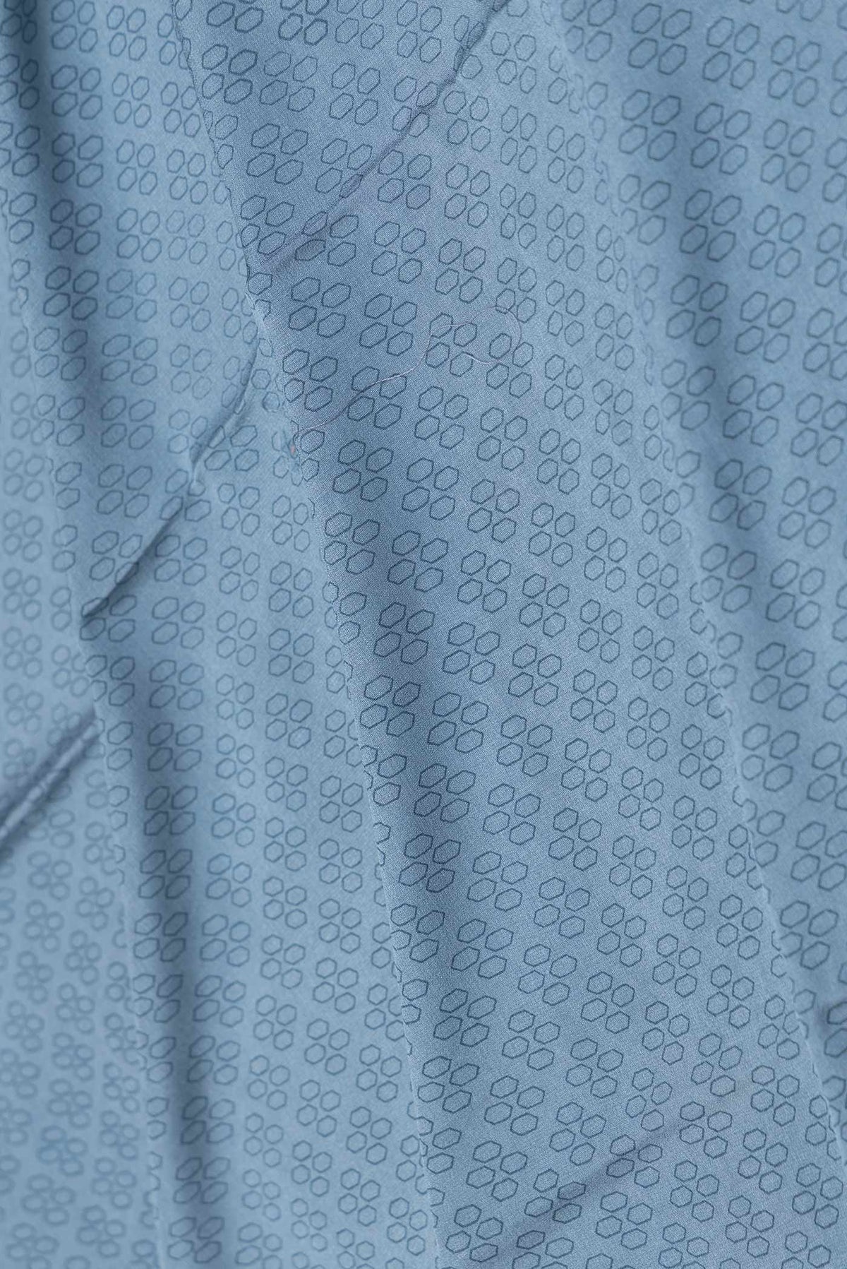 Close up of Grey Dual Tone Mysore Crepe Saree with Printed design on the body and Embroidery Border displaying folds