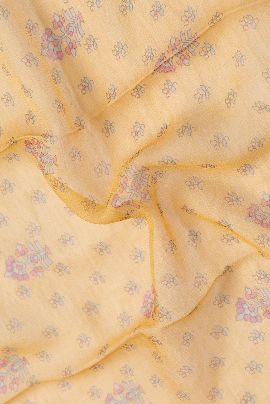 Close up of Mustard Dual Tone Mysore Chiffon Saree with Printed design on the body and Zari Border.  displaying folds