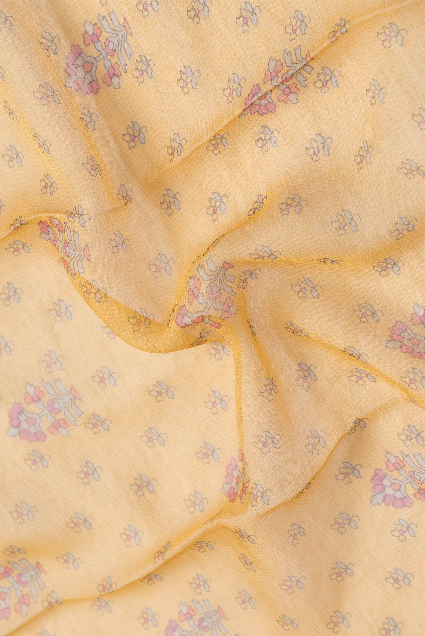 Close up of Mustard Dual Tone Mysore Chiffon Saree with Printed design on the body and Zari Border.  displaying folds