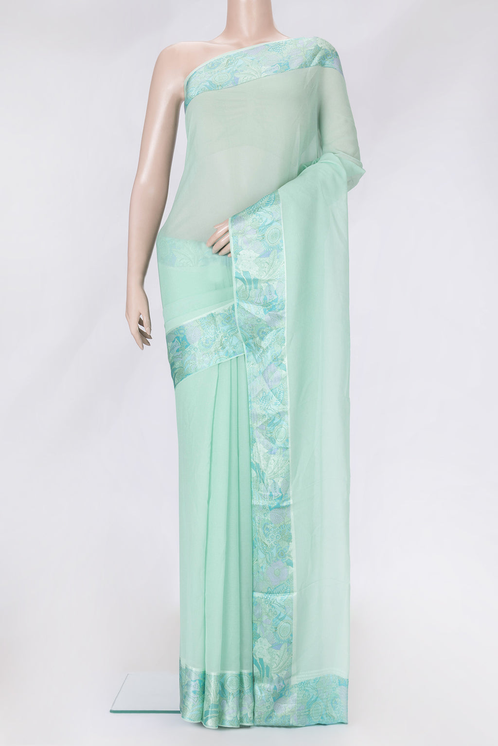 Sea Green Dual Tone Mysore Chiffon Saree with Plain Body and Thread Border.  displayed on a mannequin