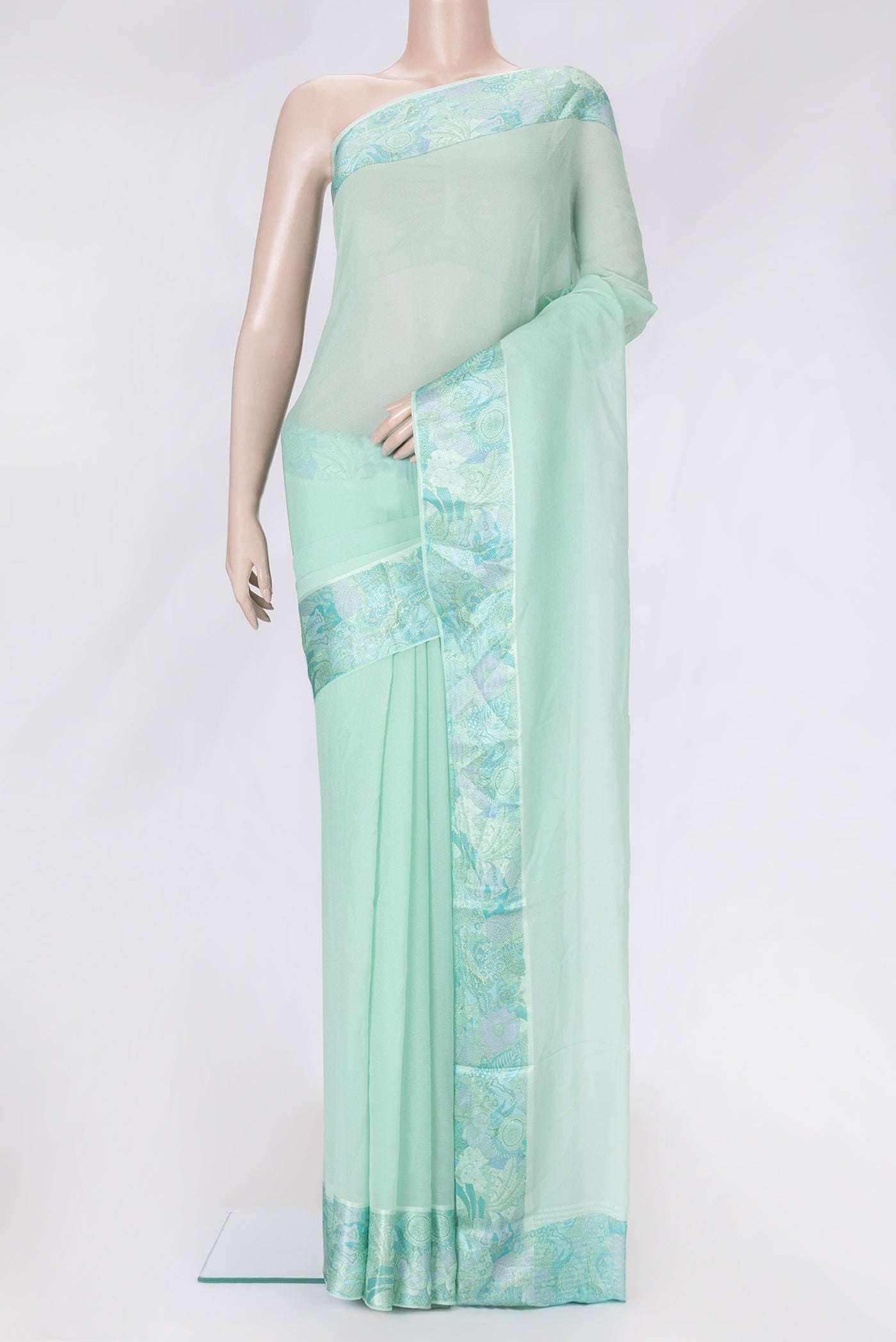 Sea Green Dual Tone Mysore Chiffon Saree with Plain Body and Thread Border.  displayed on a mannequin