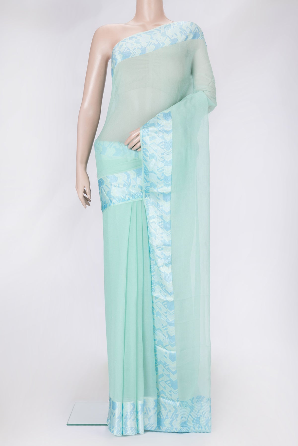Sea Green Dual Tone Mysore Chiffon Saree with Plain Body and Thread Border.  displayed on a mannequin