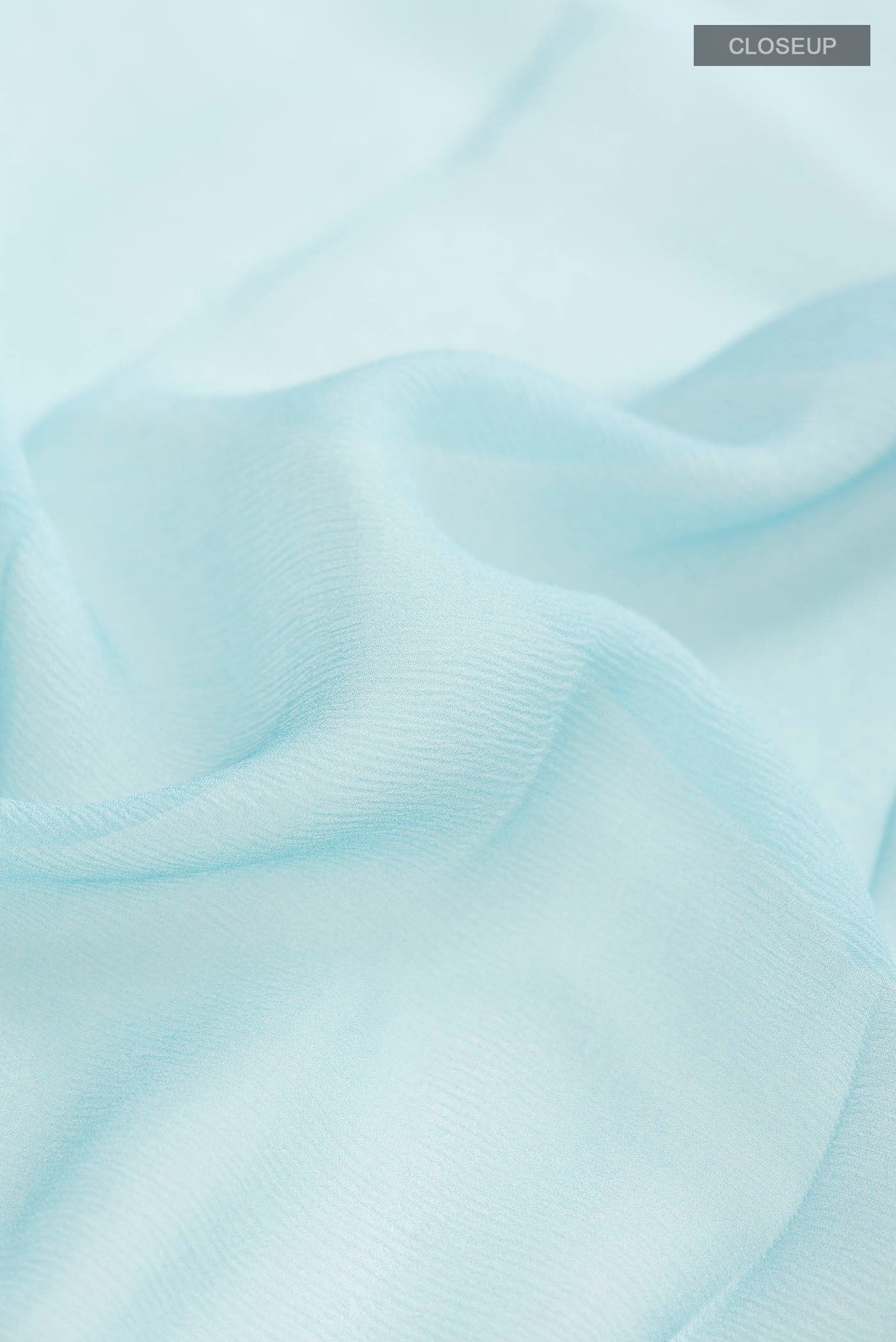 Close up of Blue Mysore Chiffon Saree with Plain Body and Checks Border displaying folds