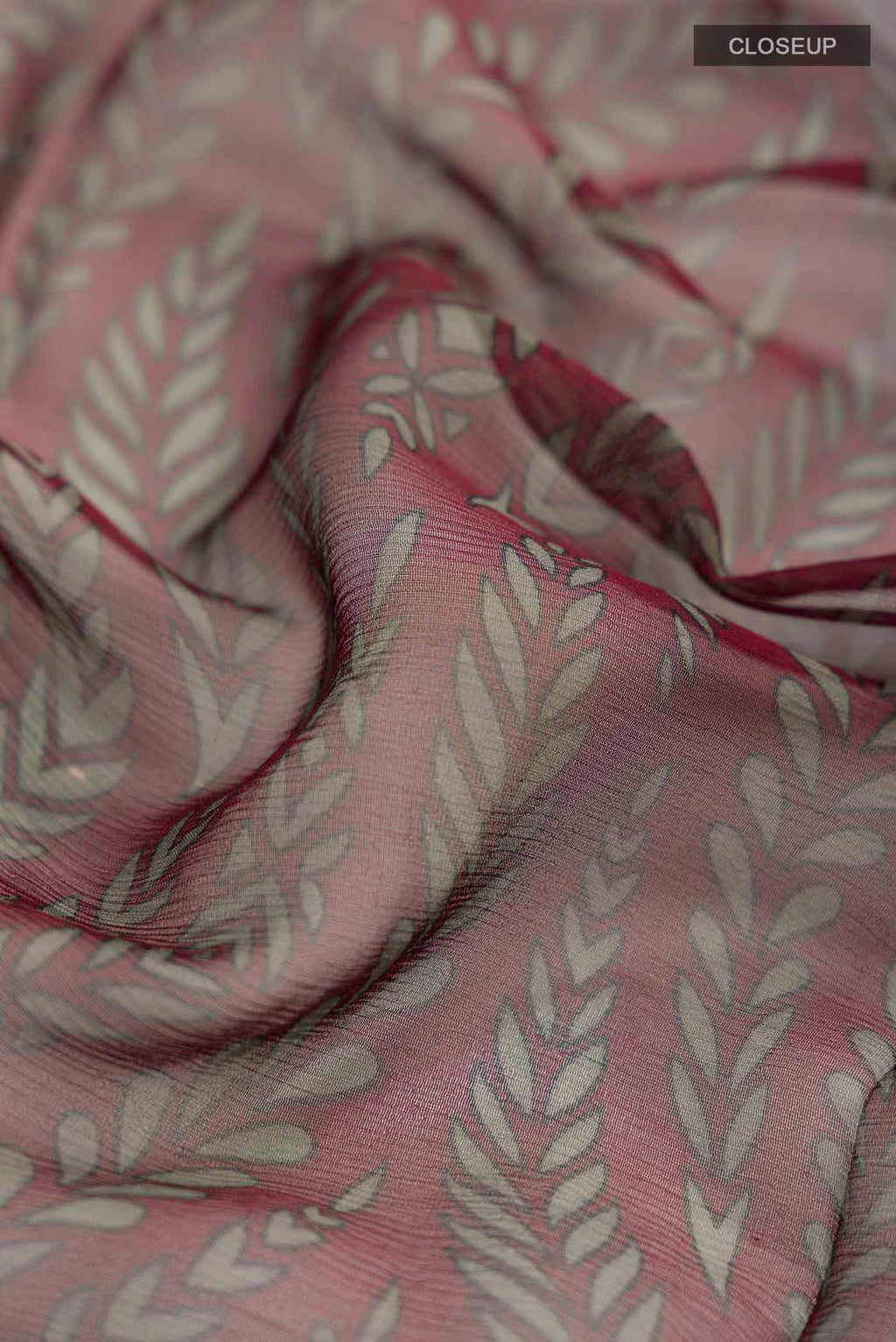 Close up of Maroon Mysore Chiffon Saree with Printed design on the body and Plain Border displaying folds