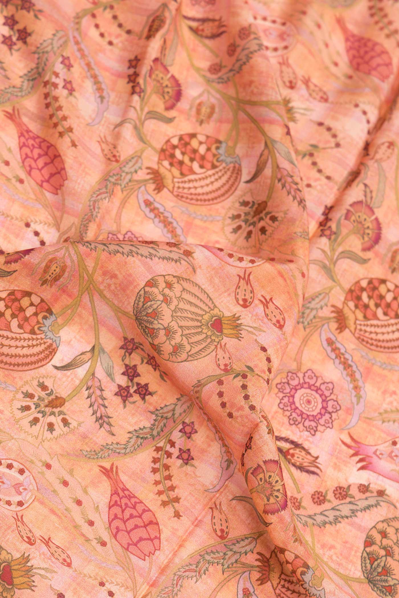 Close up of Golden Peach Dual Tone Mysore Crepe Saree with Printed design on the body and Zari Border.  displaying folds