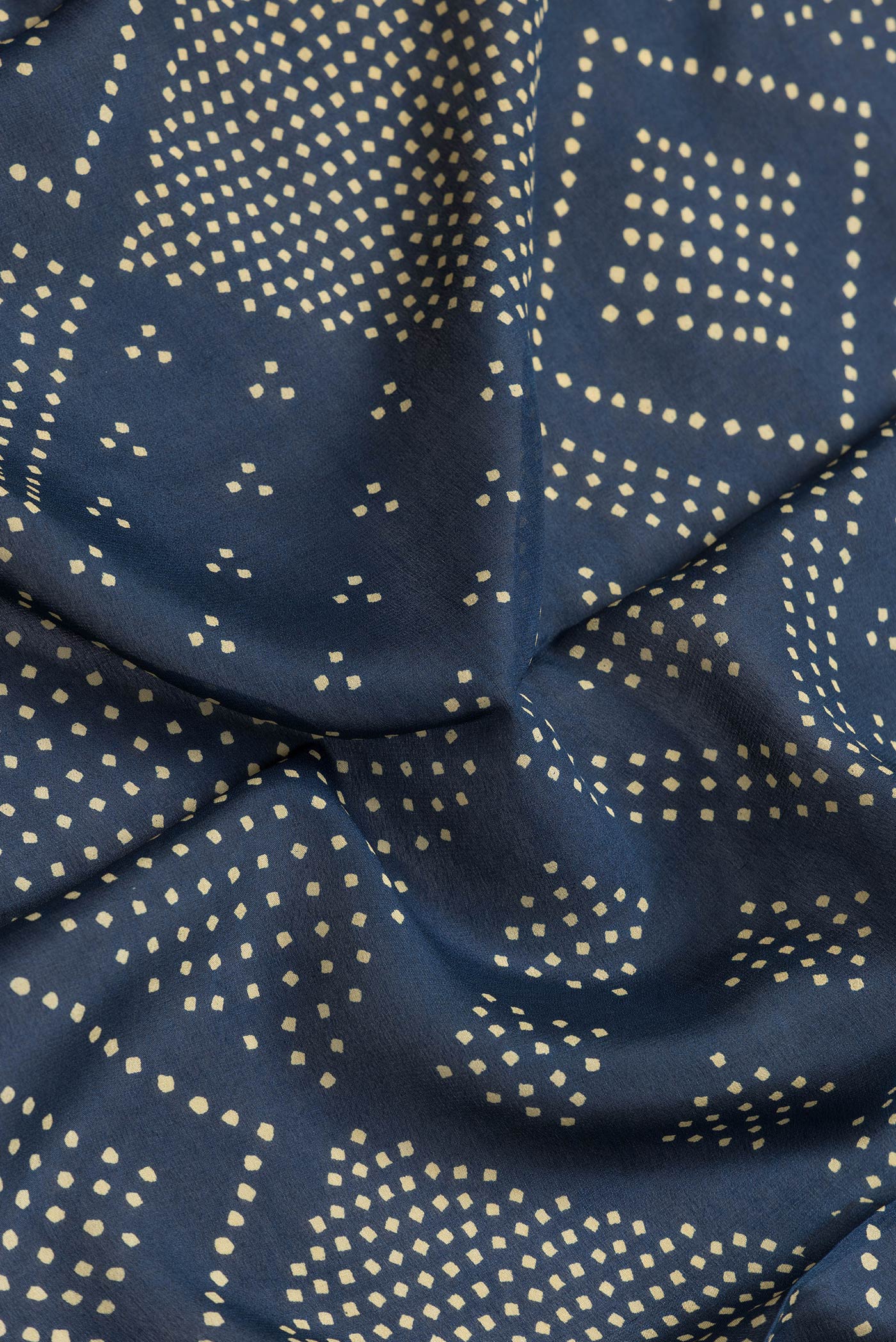 Close up of Peacock Blue Dual Tone Mysore Crepe Saree with Printed design on the body and Thread Border.  displaying folds