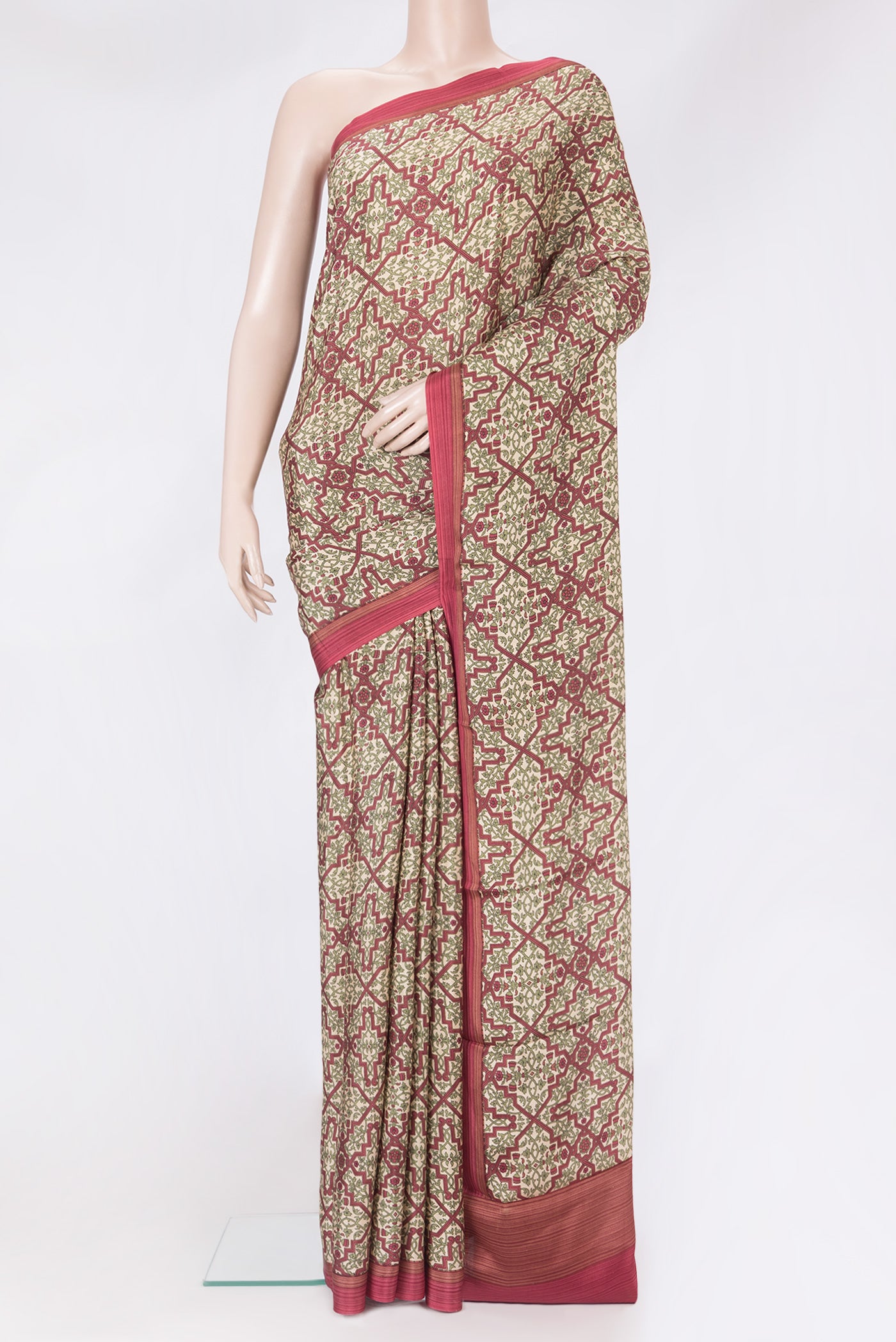 Beige Crepe Saree with Printed design on the body and Printed Border.  displayed on a mannequin