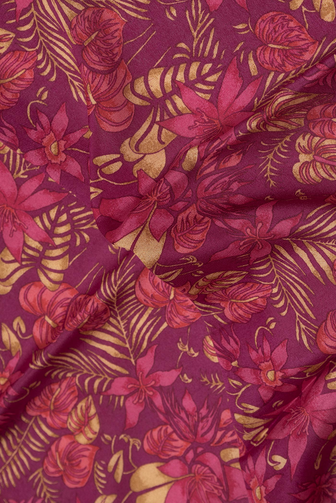 Close up of Magenta Dual Tone Crepe Saree with Printed design on the body and Thread Border.  displaying folds