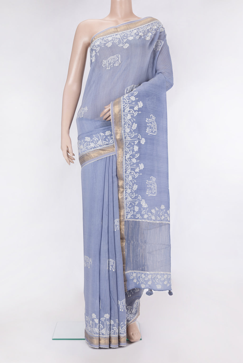 Blue Tussar Silk Saree with Embroidery on the body and Embroidery Border.  displayed on a mannequin