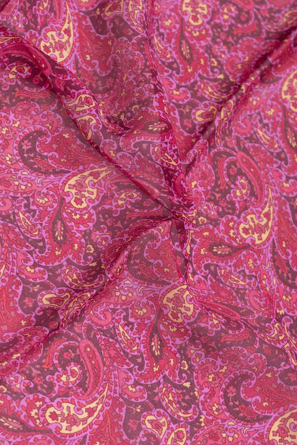 Close up of Burgundy Dual Tone Mysore Crepe Saree with Printed design on the body and Thread Border.  displaying folds