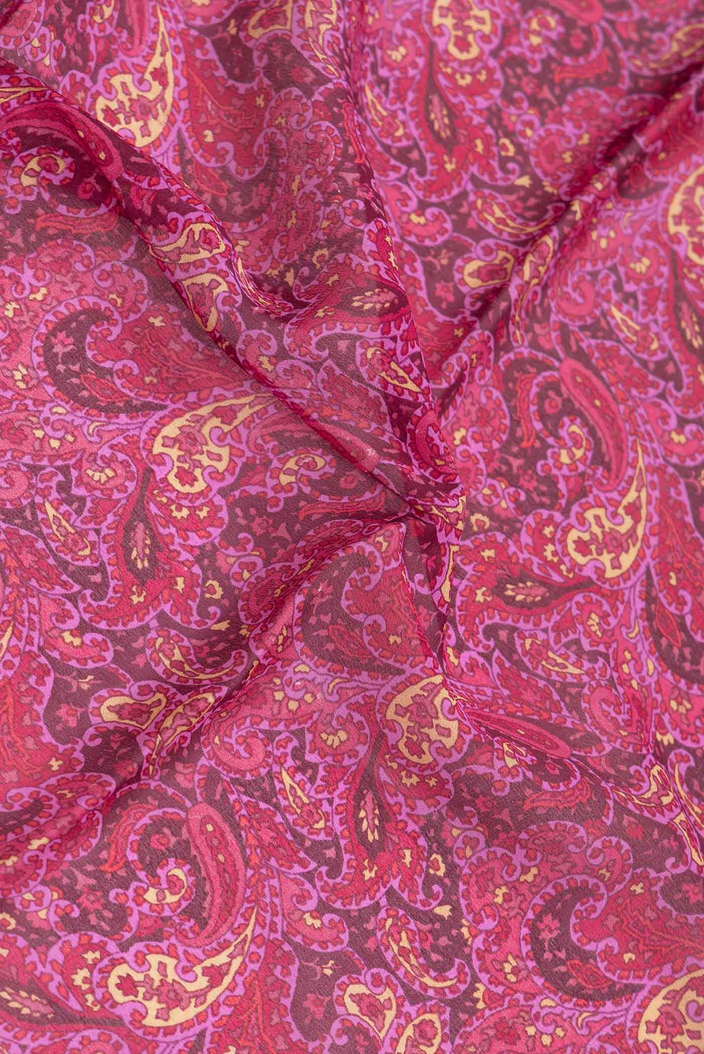 Close up of Burgundy Dual Tone Mysore Crepe Saree with Printed design on the body and Thread Border.  displaying folds