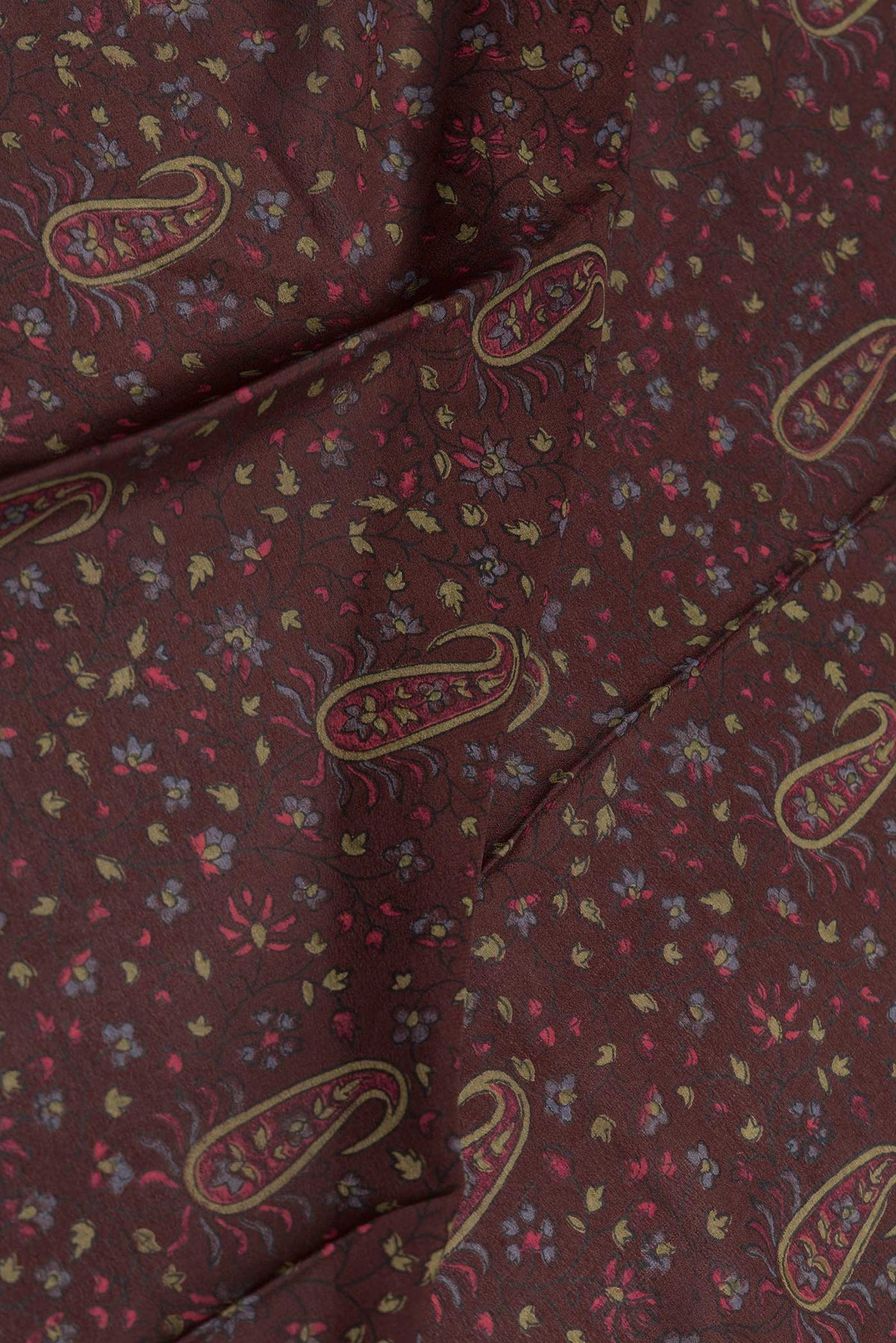 Close up of Coffee Brown Dual Tone Mysore Crepe Saree with Printed design on the body and Zari And Thread Border displaying folds