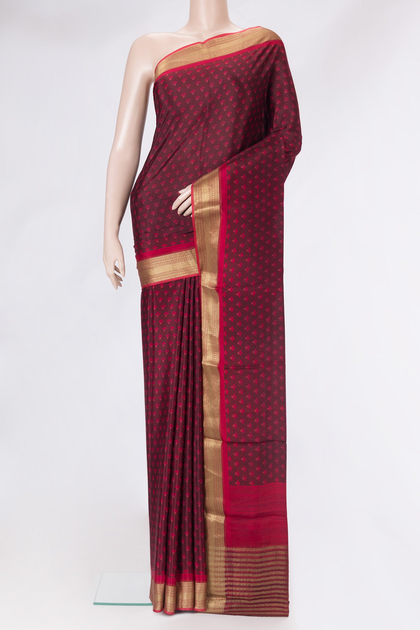 Maroon Dual Tone Crepe Saree with Printed design on the body and Zari Border.  displayed on a mannequin