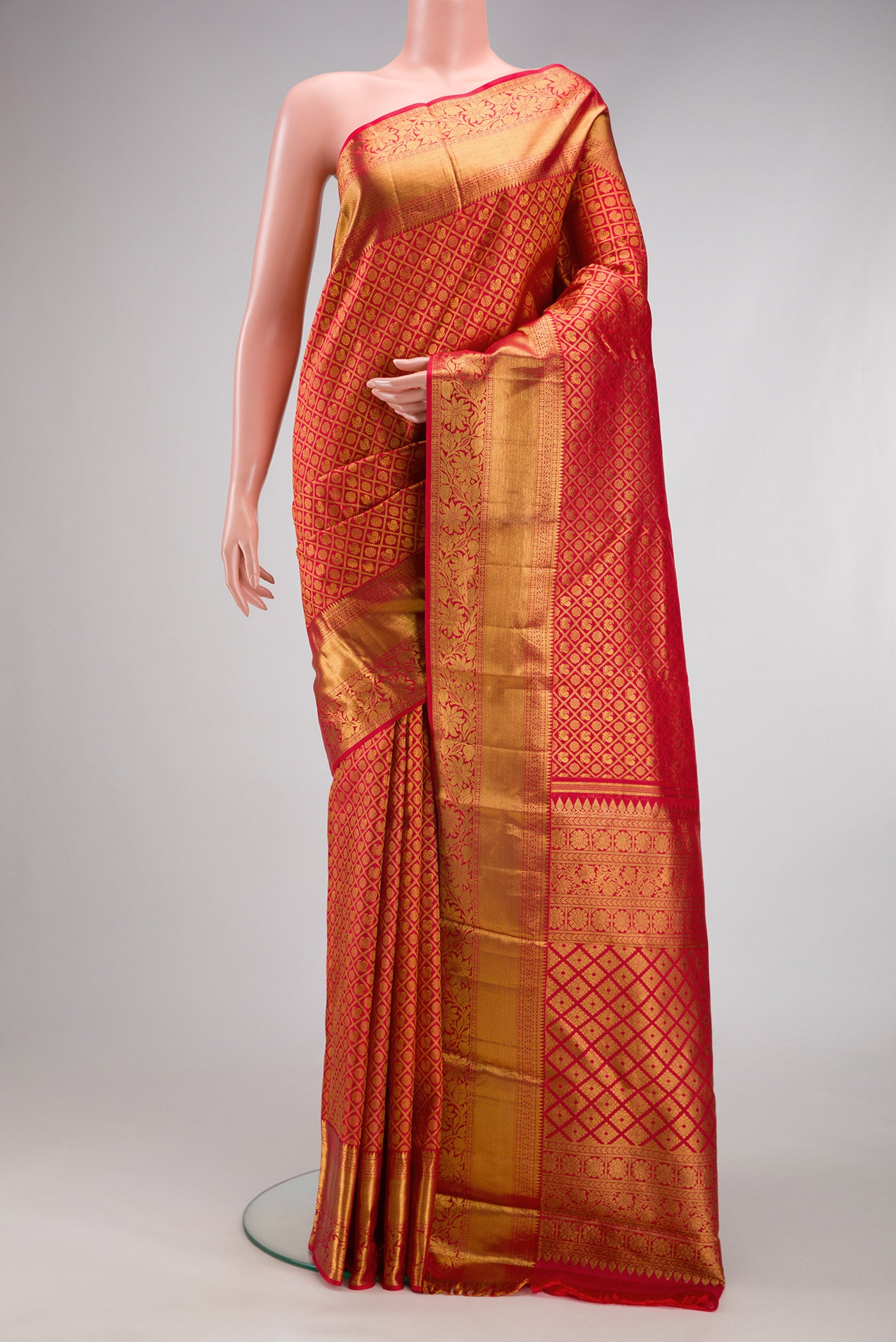 Red Kanchipuram Silk Saree with Zari Brocade on the body and Fancy Border.  displayed on a mannequin
