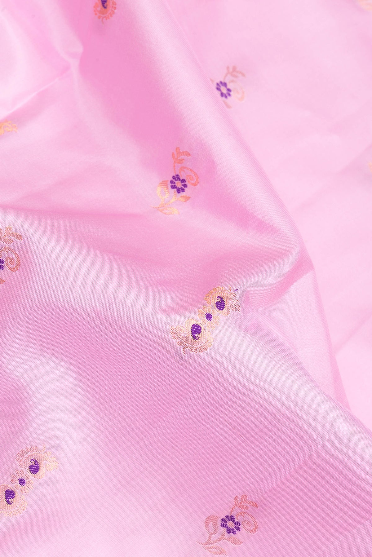 Close up of Pure Silk Rose pink Dual Tone Soft Saree with Zari And Thread Butta on the body and Fancy Border.  displaying folds