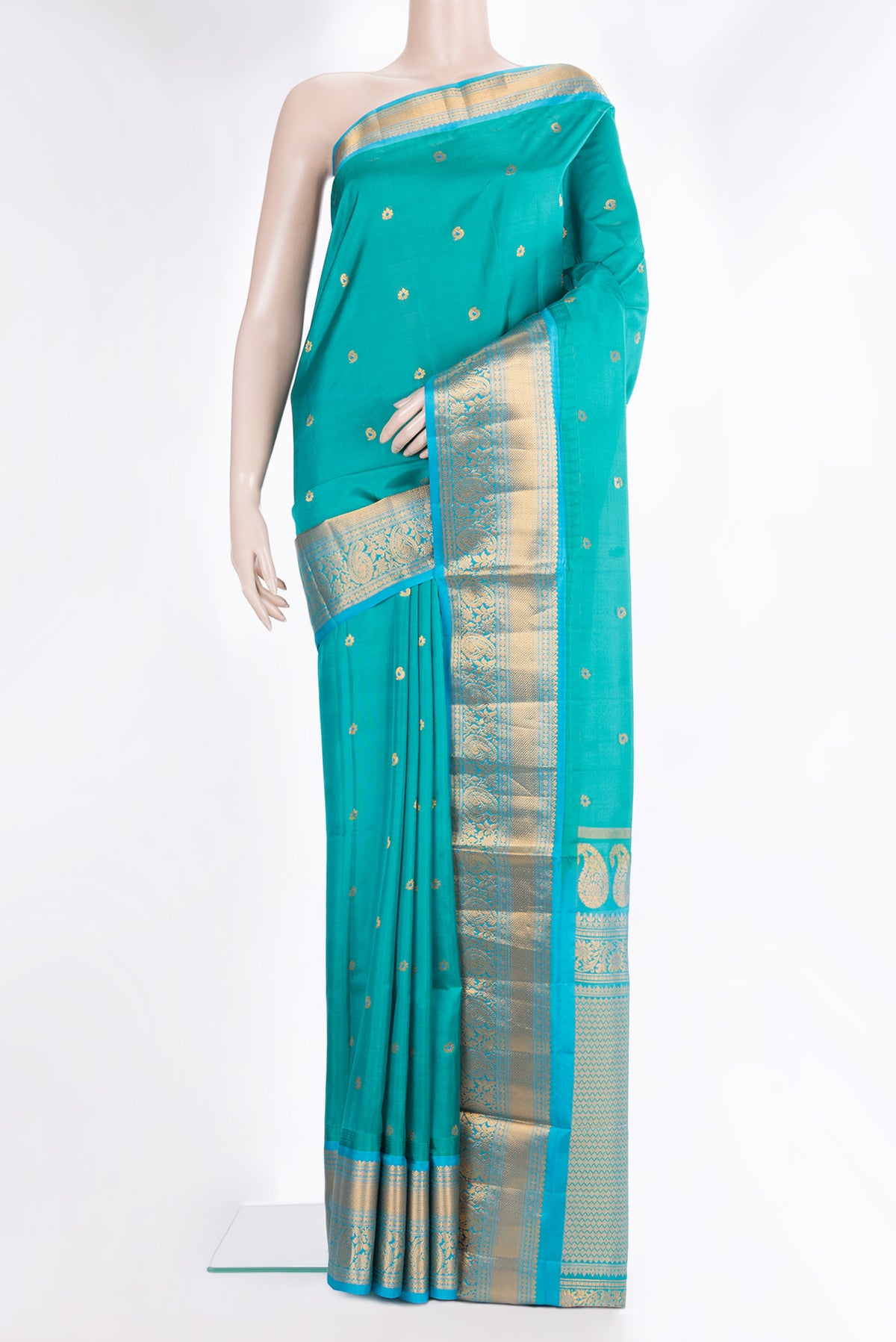 Pure Silk Peacock Blue Dual Tone Soft Saree with Zari And Thread Butta on the body and Fancy Border.  displayed on a mannequin