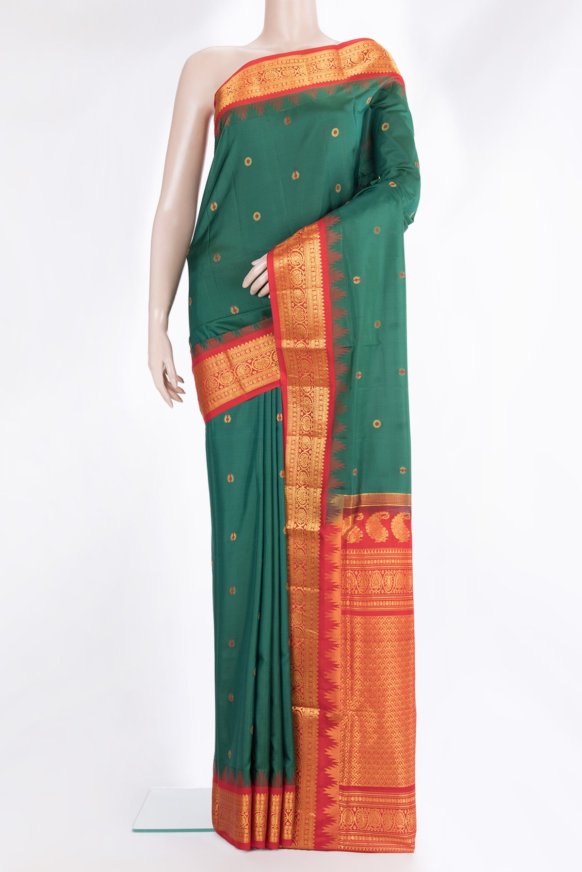 Pure Silk Bottle Green Dual Tone Soft Saree with Zari And Thread Butta on the body and Fancy Border.  displayed on a mannequin