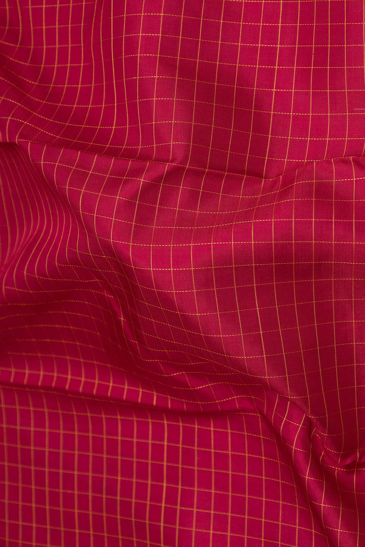 Close up of Maroon Dual Tone Kanchipuram Saree with Checked design on the body and Zari Border displaying folds