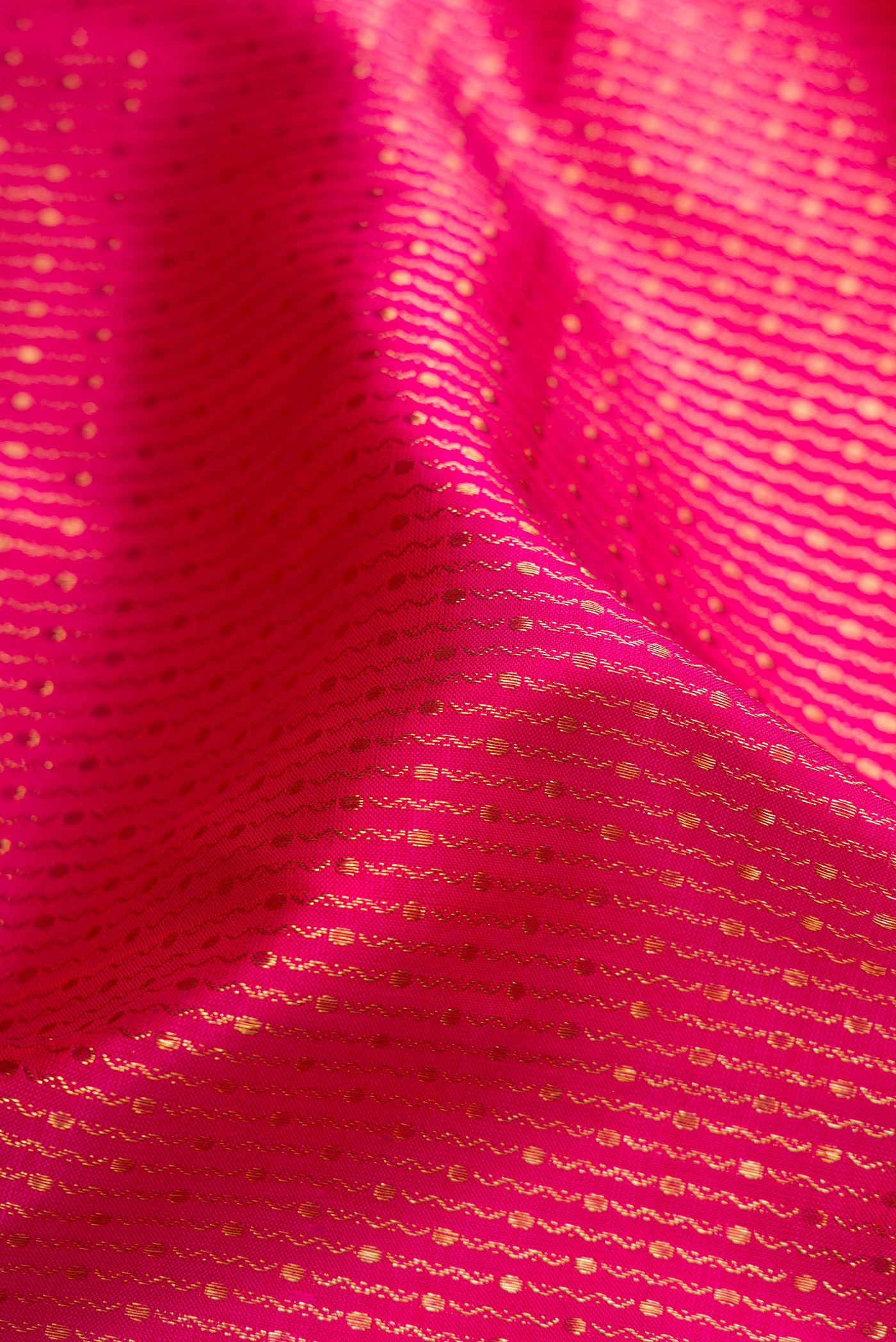 Close up of Pink Dual Tone Kanchipuram Silk Saree with Zari Brocade on the body and Zari Border.  displaying folds