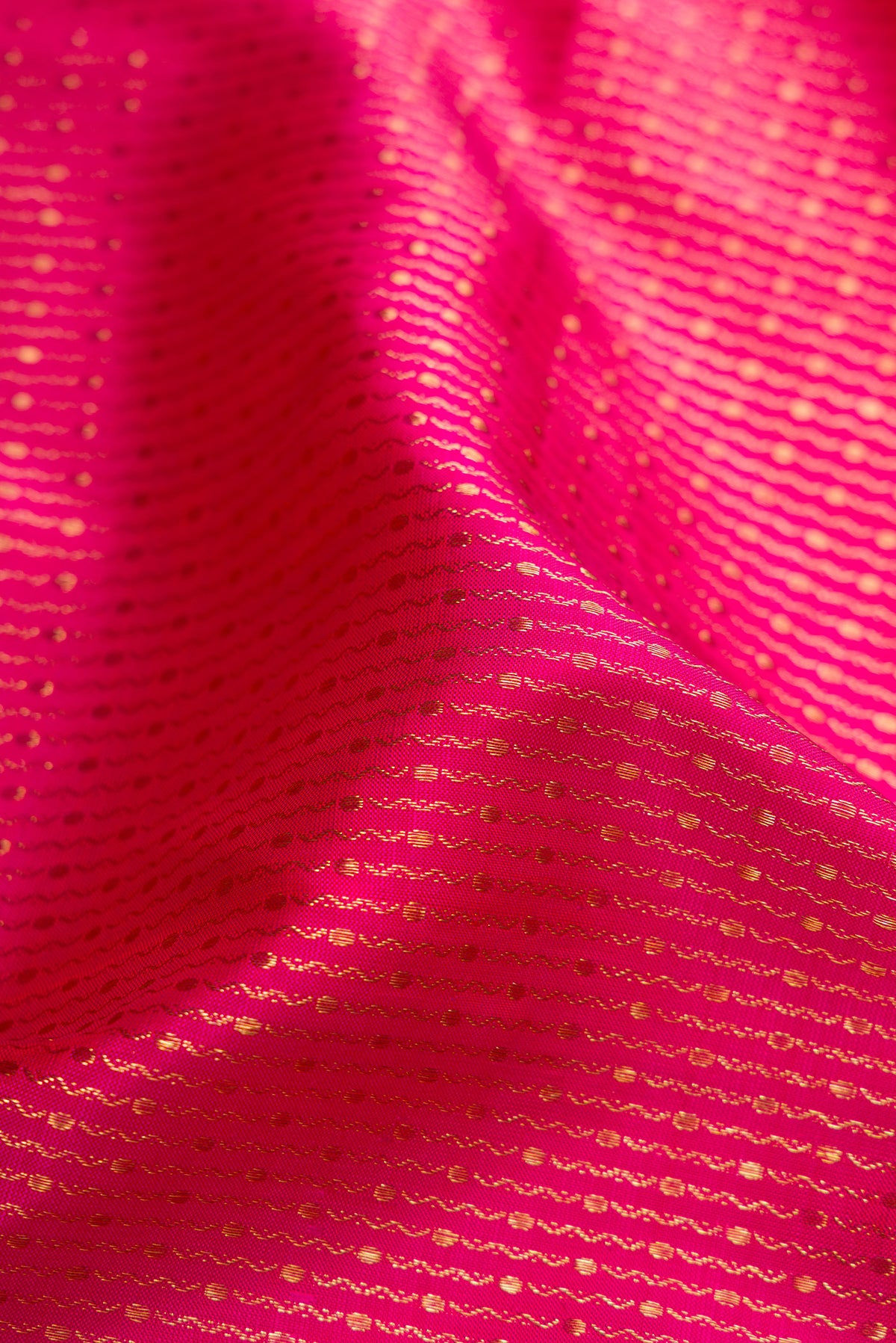 Close up of Pink Dual Tone Kanchipuram Silk Saree with Zari Brocade on the body and Zari Border.  displaying folds