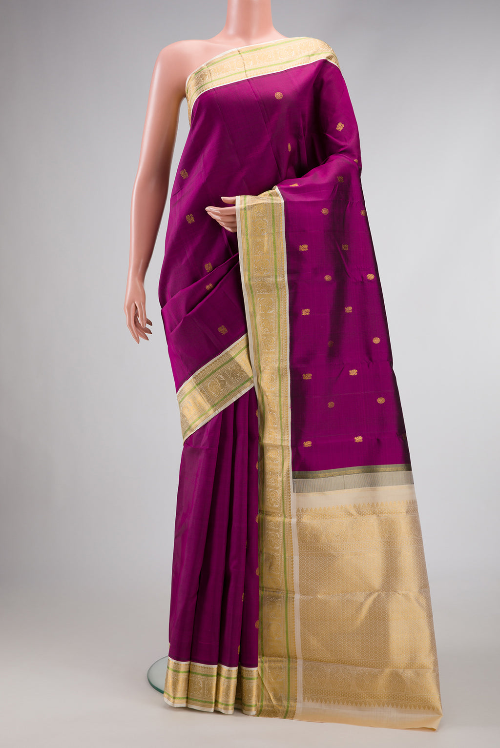 Pure Silk Pure Zari Magenta Dual Tone Kanjivaram Saree with Zari Butta on the body and Zari Border.  displayed on a mannequin