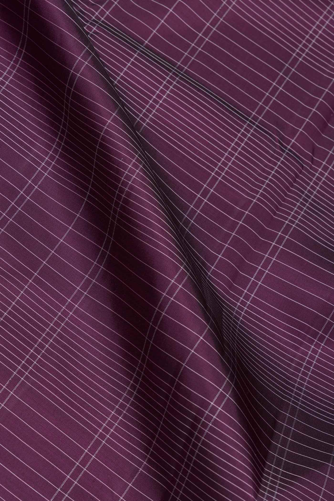 Close up of Burgundy Dual Tone Kanjivaram Saree with Checked design on the body and Thread Border.  displaying folds