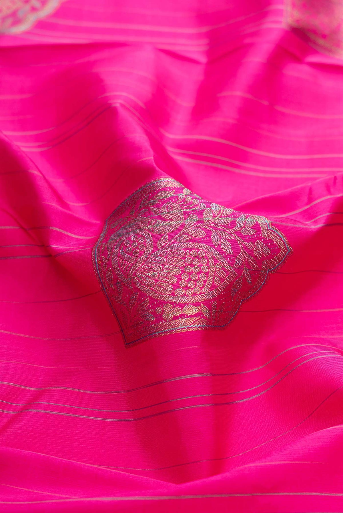 Close up of Dark Pink Dual Tone Kanchipuram Silk Saree with Zari And Thread Butta on the body and Without Border displaying folds
