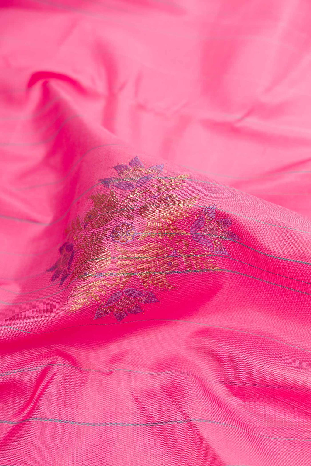 Close up of Pure Silk Pure Zari Pink Dual Tone Kanchipuram Saree with Zari And Thread Butta on the body and Without Border displaying folds